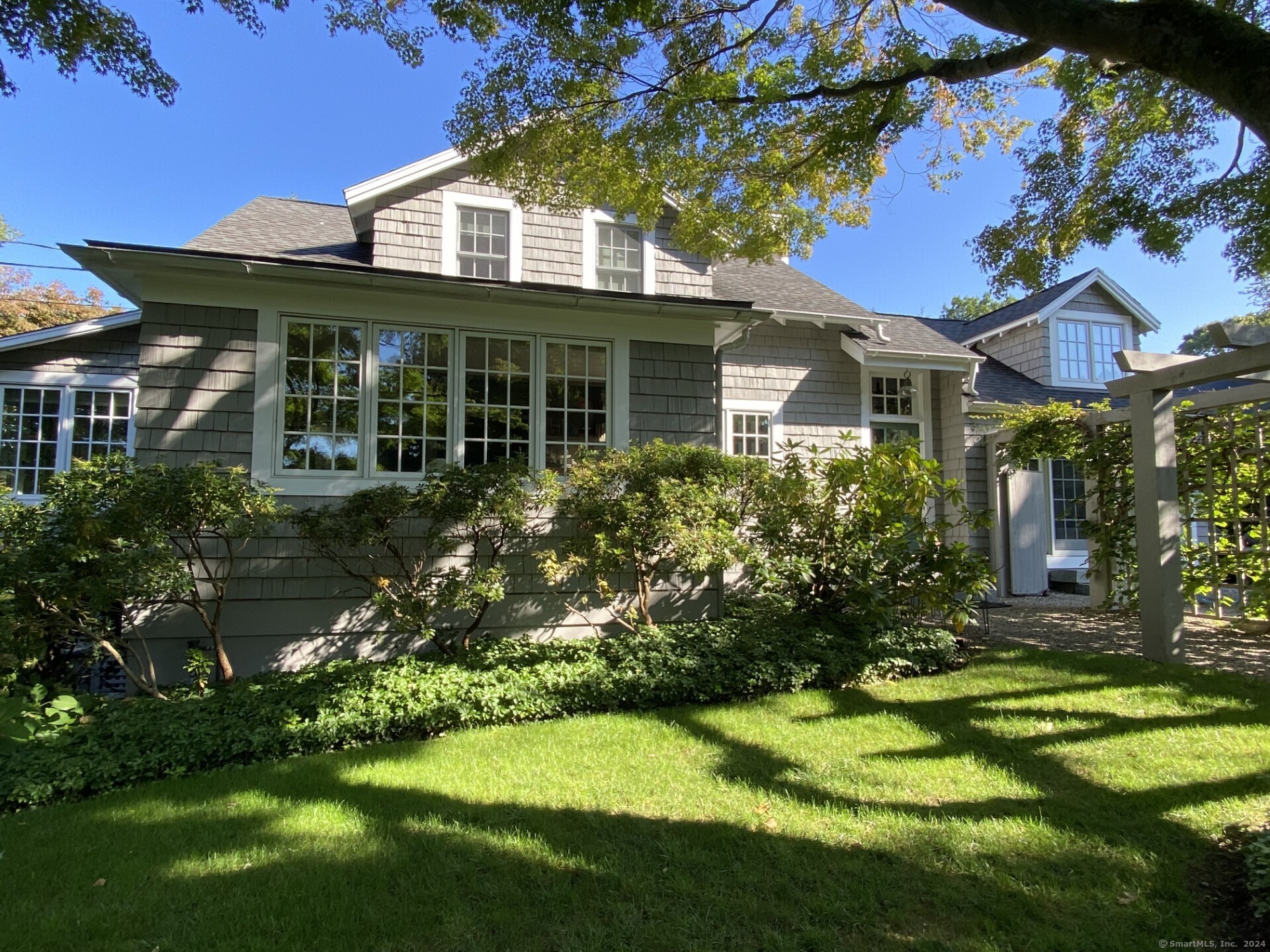 Rowayton chic! This light-filled colonial cottage offers an easy and relaxing lifestyle one block from Pinkney Park and village center. Designer renovated and decorated with a Provence-like feel, this beautifully furnished 4BR home boasts sophistication and tranquility with its stunning interior finishes, artwork and many large windows. A charming trellis walkway leads you inside to an open floorplan including a Chef's kitchen with eat in dining area, beautiful living room w fieldstone gas fireplace and multiple cozy seating areas, comfortable den and sunroom/game table area. A spacious and gorgeous first floor, primary bedroom with vaulted beamed ceiling, transom windows and sliders opens to a private spa-like garden and patio dining area. Three additional lovely second floor bedrooms and an elegantly landscaped exterior complete this delightful oasis in this welcoming and happening little coastal town. Will consider a 6 month or 18 month lease or longer.