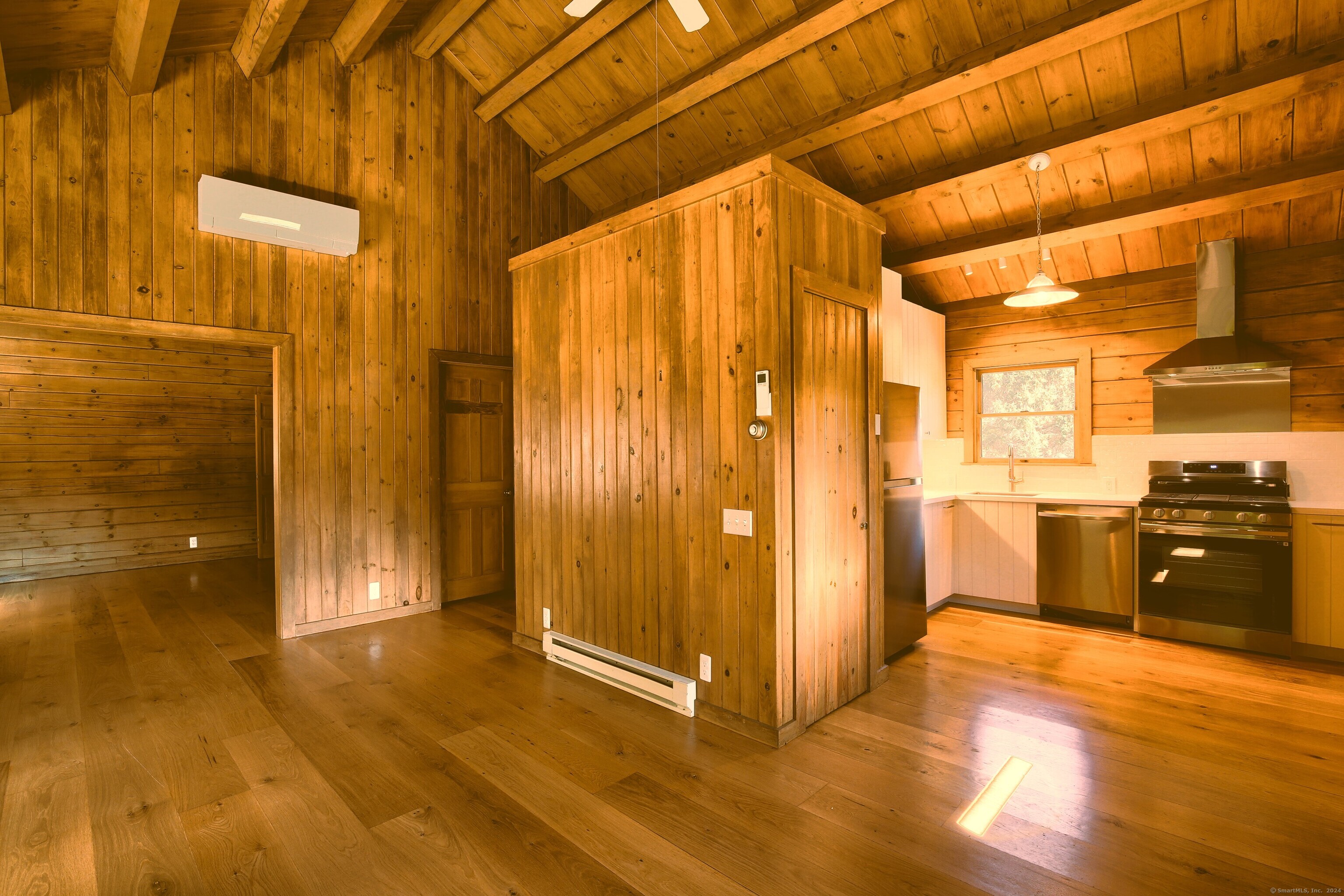 This charming country log cabin, beautifully renovated in 2024, offers a serene escape perfect for years of enjoyment. The kitchen boasts new cabinetry, stainless steel appliances, and a pantry, ideal for culinary enthusiasts. A cathedral ceiling in the main living area is enhanced by a cozy gas fireplace, creating a warm ambiance. The large bay window and sliding doors open to a private back deck, flooding the space with natural light and providing a wonderful spot to unwind. Elegant touches abound, from gleaming hardwood floors to a sparkling new bathroom. Both the bedroom and living area feature double closets for ample storage. Modern comforts include new mini-splits for heating and cooling, adding to the cabin's appeal. A two-car garage houses the laundry area and an additional heater. Plus, you're just a short stroll away from a lovely riverside picnic spot and the popular Roxbury Kitchen for a delicious meal. This cabin is perfect for those seeking comfort and convenience in a picturesque setting!