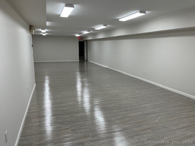 Versatile Finished Lower-Level Space in Prime Downtown Branford Location! This spacious 1, 617 sq ft finished basement, accessible from the alleyway, offers endless potential in the bustling heart of downtown Branford, directly across from the green. Ideal for storage, office, or creative workspace needs, this open floor plan includes a private restroom and ample flexibility to suit a range of business operations. Take advantage of this conveniently located well-maintained space.