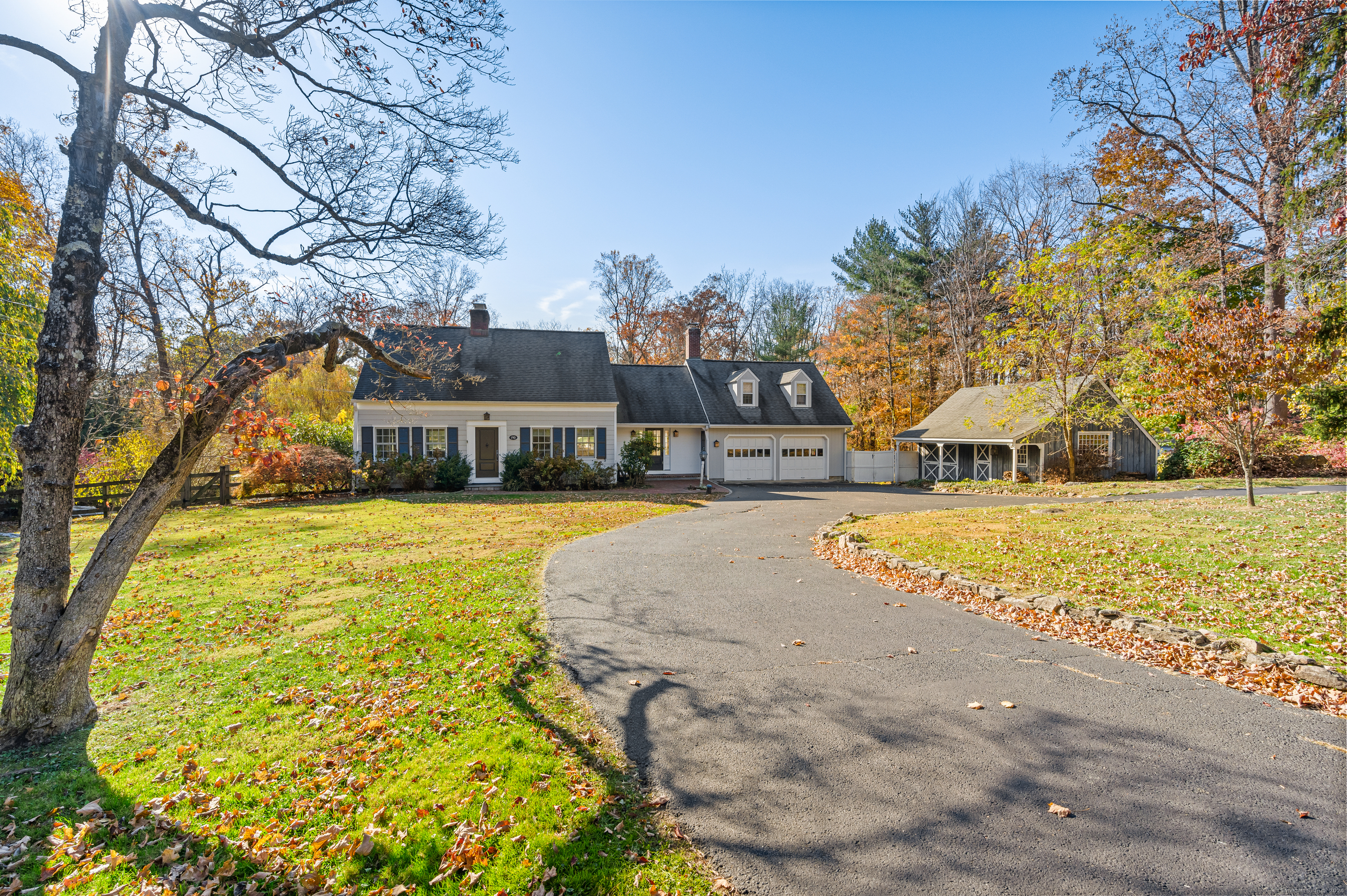 Welcome to your dream retreat in Weston - a picturesque cape with classic charm & modern elegance. This enchanting 4-bed, 2.5-bath home lives larger than it appears, w/multiple areas to gather or retreat. The heart of the home is a renovated kitchen, a chef's delight w/high-end Thermador and Bosch appliances. The adjacent living room w/dining area features a cozy fireplace, built-ins, & exposed beams, creating a warm atmosphere for entertaining. Just off the kitchen/family room, is a cozy homework nook w/fireplace and a sunroom overlooking the parklike property. The primary BR suite enjoys a private setting above the garage, while 3 additional BRs and a full bath are accessed via the main staircase. The finished, walkout lower level w/ fireplace, provides an additional 405 SF of living space. Step outside to discover a private oasis with a stunning freeform gunite pool, beautifully tiered grounds, lush landscaping, specimen trees, and a tranquil meadow. The lower yard is expansive & level, ideal for games, sports training, and has an inviting outdoor firepit, perfect for memorable evenings under the stars. Adding to the charm is a versatile barn, offering expansion possibilities. A circular drive enhances the curb appeal & welcomes you home. Centrally located, this gem is within reach of Weston's award-winning schools and a short drive to Westport's vibrant beaches, shops, & train to NYC. Embrace a lifestyle of tranquility, convenience, and fun in this charming Weston home.