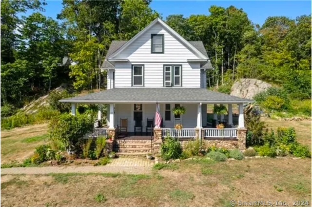 Step into timeless charm with this beautifully renovated historic home, nestled in the heart of Branford, CT. Built in 1890, this gem combines historic elegance with modern luxury. As you enter, be greeted by the warmth of refinished hardwood floors that flow seamlessly throughout the spacious, sunlit rooms. Imagine cooking in your new kitchen, with gleaming granite countertops and state-of-the-art stainless steel appliances. The open layout effortlessly connects the kitchen to a cozy dining area-perfect for entertaining family and friends. Rest easy knowing that all the major updates are already done for you, including a new roof over the garage, updated electrical systems, and a new gas steam boiler-added in 2020 for reliable comfort and efficiency.  The home boasts four spacious bedrooms, providing plenty of room for family and guests. The partially finished attic can be perfect for a home office, gym, or playroom.  Step outside to a serene backyard and relax on the stunning wrap-around front porch with your morning coffee or evening tea, enjoying the tranquility of the lush, wooded surroundings. A paradise for nature enthusiasts with nearby hiking trails and Branford River access for kayaking adventures. Located just minutes from vibrant town amenities, convenient I-95.