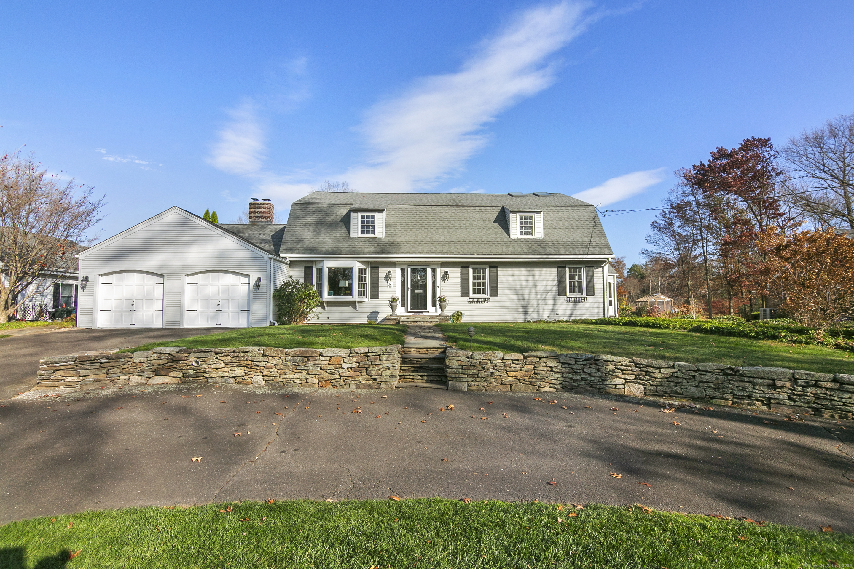 Welcome to 98 Waterside Lane, a truly unique waterfront home nestled along the serene shores of Wood Pond in West Hartford. This exceptional property boasts an impressive layout with over 4, 000 square feet of updated and meticulously crafted living space, offering breathtaking views of the water from every room. Step into this impeccably maintained home and be greeted by gleaming hardwood floors throughout, freshly painted walls, and an abundance of natural light. The heart of the home is the bright and spacious newly renovated kitchen, highlighted by vaulted ceilings, skylights, and a large central island with quartz countertops. Equipped with premium appliances including a Wolf induction cooktop, Viking Professional double oven, and wine refrigerator, this kitchen is designed for both everyday living and entertaining. The kitchen flows seamlessly into the formal dining room, complete with beautiful built-ins and stunning views of the pond. The expansive living room features a cozy pellet stove and recessed lighting, providing a warm and inviting atmosphere. The library/den features floor-to-ceiling bookshelves and a built-in desk with extra shelving, perfect for work or relaxation. The main floor features one of two well-appointed primary suites with an en-suite bathroom that includes a heated floor and walk-in shower.