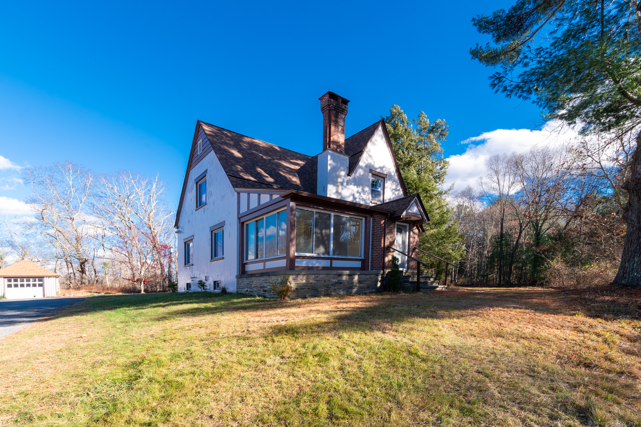 This charming home is full of character, has been meticulously cared for by its current owner and is move-in ready. Beautiful hardwood floors, a lovely heated sunroom, tons of storage - including a walk-up attic, new roof this year with a transferable warranty, a circular drive and huge garage are just some of the features you will find here. All set on 13.4 acres with Stony Brook running through the western side. You won't want to miss this one!