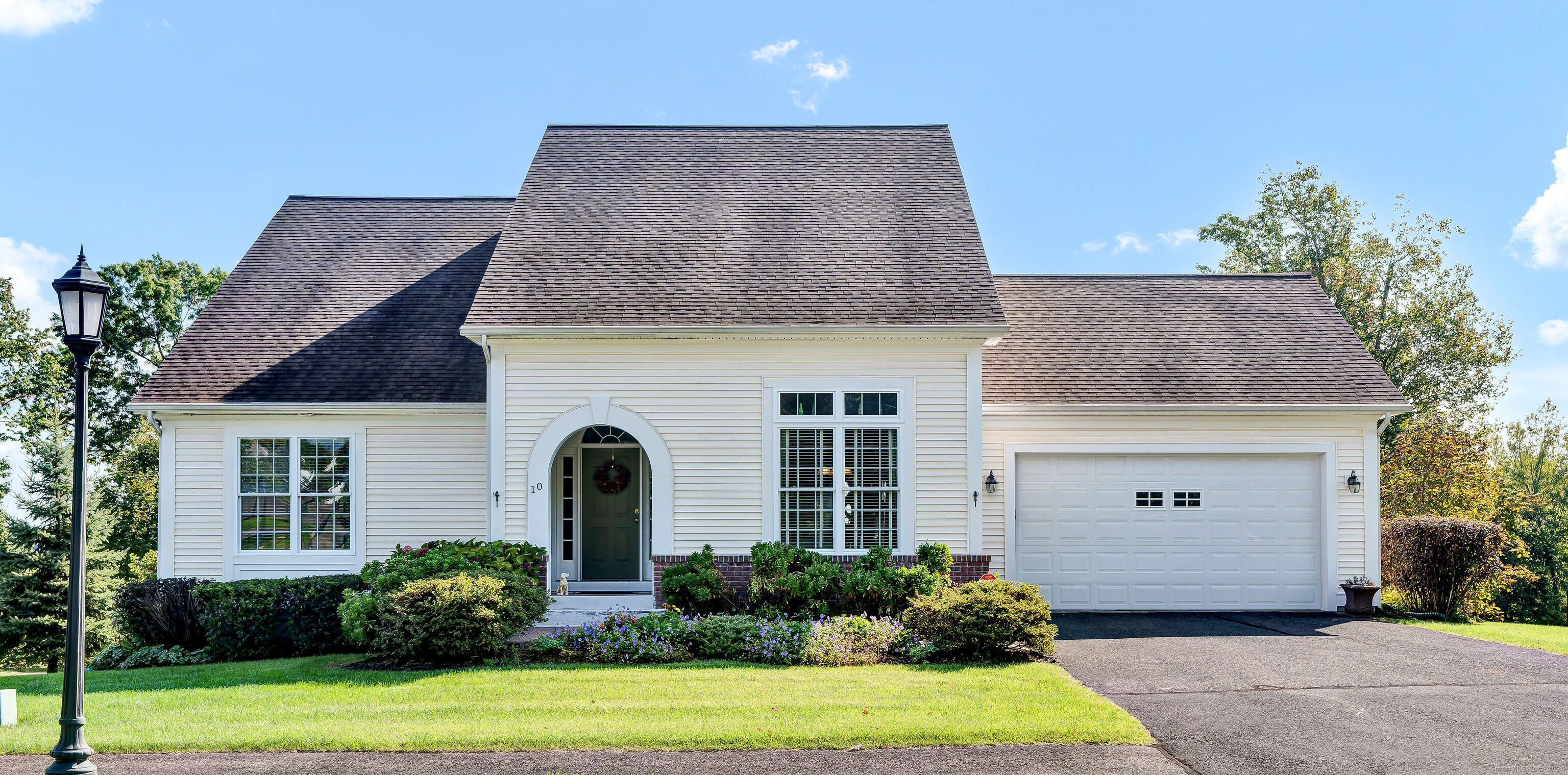 Welcome home to 10 Long Green Terrace. This elegant home in highly sought after Evergreen 55+ Community is sure to impress. Enter into the expansive two story foyer which flows into the formal dining room and living room with gas fireplace, cathedral ceiling, and large windows to enjoy the stunning view. The custom eat in kitchen features gleaming hardwood floors, stainless steel appliances, beverage chiller, and granite countertops. Off the living room is a light and bright three season room. The primary suite features a newly remodeled bathroom with soaking tub and custom shower, a walk in closet, and plenty of windows to let the natural light pour in. A second bedroom is included on the main level, as well as a full bathroom, and a convenient laundry room. At the top of the stairs enjoy a loft that overlooks the living room, as well as a nicely sized bedroom with a walk in closet, and a full bathroom. This home has many features including a sprinkler system, audio system, beautiful hardwood floors, high ceilings, and crown molding throughout. Spacious two car garage. Full walkout basement for future build if needed. This home has been meticulously maintained, don't miss the opportunity to view this well appointed home.