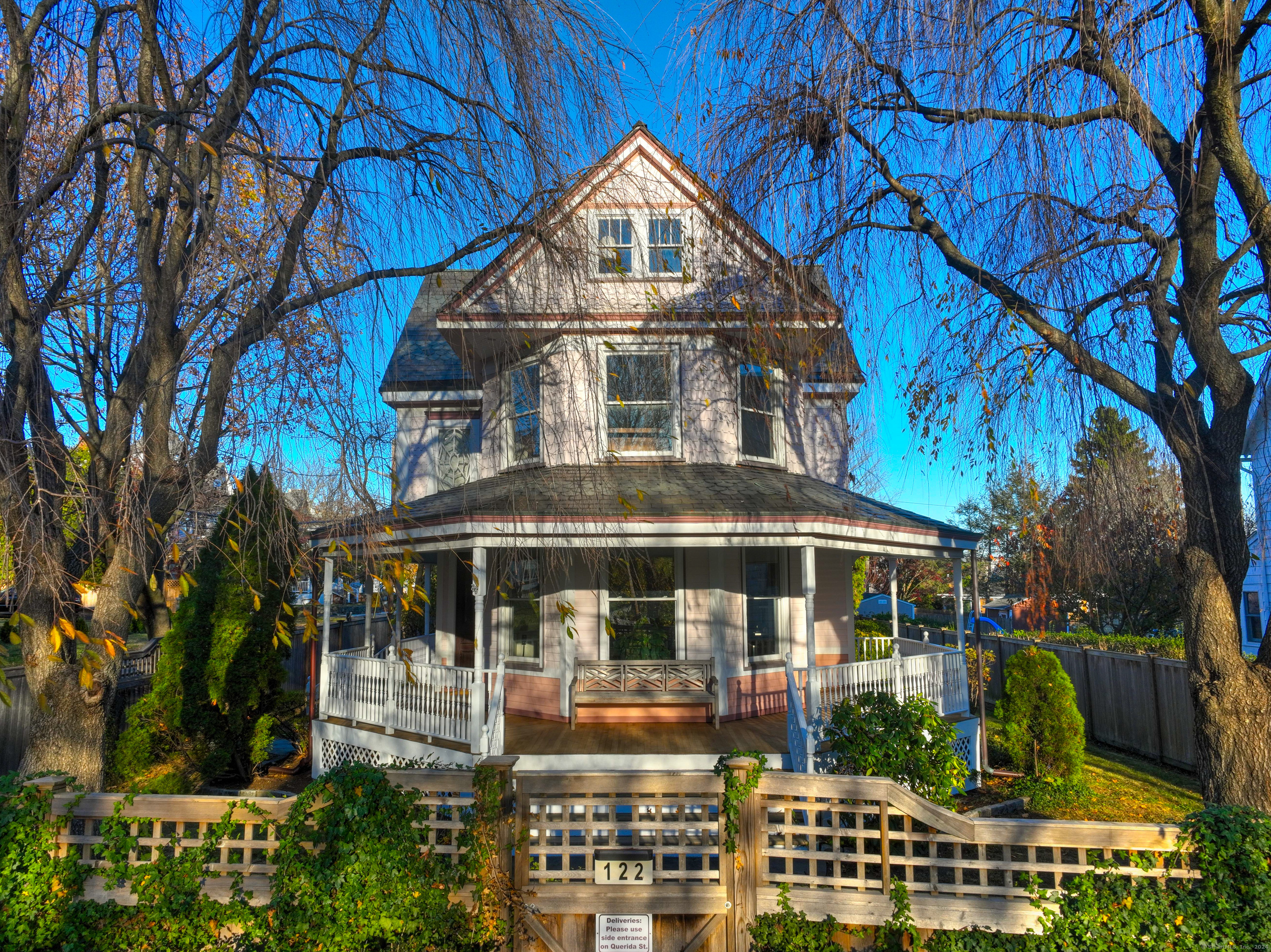 Step into the elegance of a bygone era with this unique 1894 Queen Anne Victorian home, set in the Historic Stratfield neighborhood with scenic views of Brooklawn CC golf course. Spanning 2,764 sq ft, this meticulously preserved & updated residence offers 4 BRs & 3 full baths, showcasing exquisite period detailing throughout. You'll be greeted by rich wood paneling, built-in cabinetry, & vibrant stained-glass windows that capture the essence of Victorian craftsmanship. The fully renovated kitchen blends modern convenience with historical charm; a Viking gas range, farmhouse sink, granite counters & a tin ceiling that harks back to the home's origins. Relax by the cozy gas fireplace or entertain in style in the dining room, complete with a large arched stained-glass window & vintage mirror. The 2nd floor hosts the primary suite, where a luxurious mosaic tile floor complements the period vanity with silver-plated sink and fixtures. 2 addl. BRs & a full bath complete this level. On the 3rd fl, you'll find 2 versatile rooms ideal as addl BRs or offices, plus attic storage. A bright mahogany conservatory with copper roof extends from the kitchen, perfect for enjoying sunlit mornings. Outside, a stately 100 year slate roof crowns the residence, preserving its timeless appeal. Detached 2-car garage with spacious loft above & updated mechanicals in the dry basement. This home offers a rare opportunity to own a piece of Fairfield's history, meticulously maintained and ready for you!