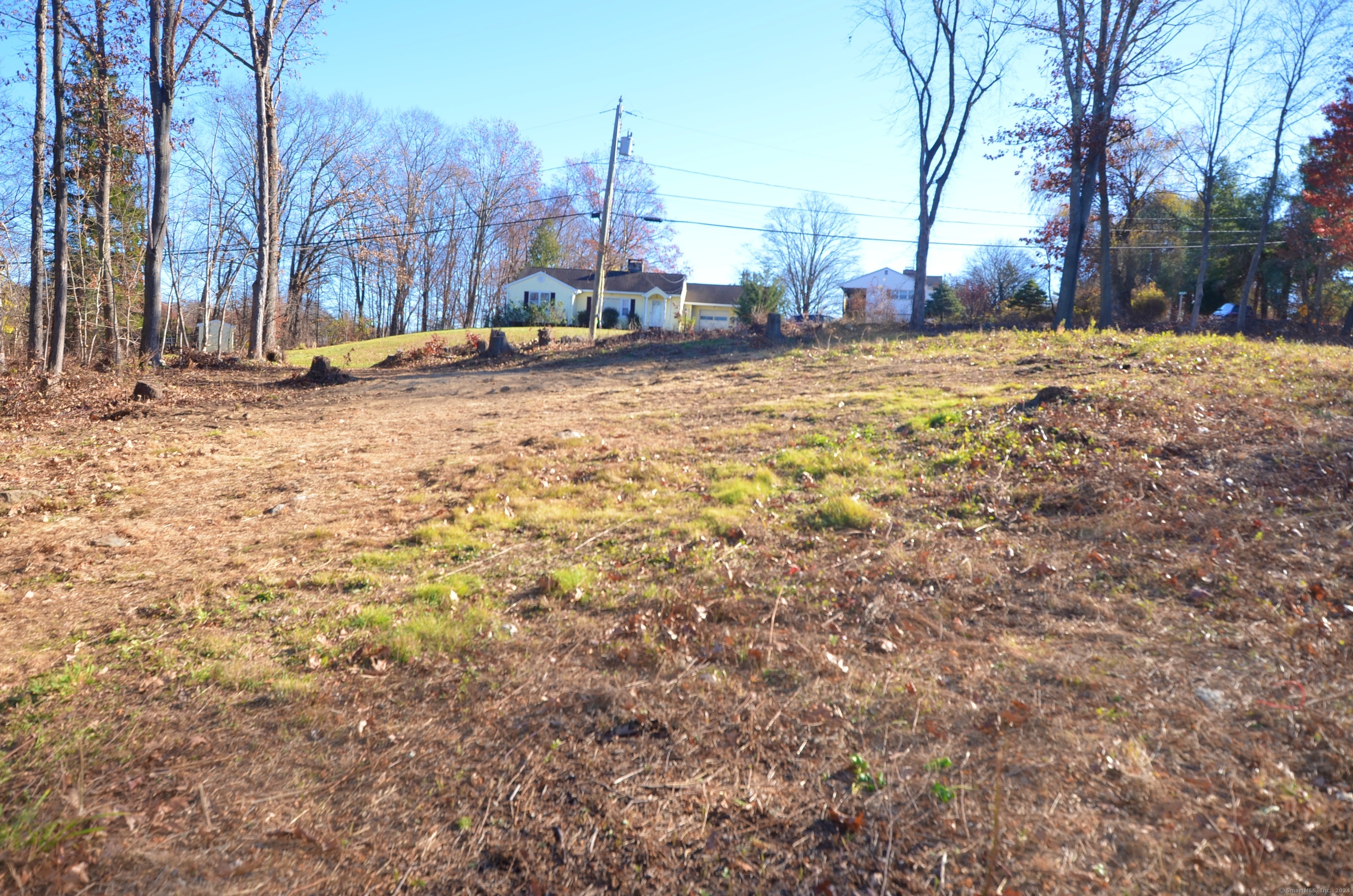 Approved 1.3 acre building lot located close to Sunset Hill Golf Club and Route 25. Convenient to Federal Road, I-84 and down county. Lot is mostly clear, mostly level toward the road and gently slopes to another area with an existing tennis court. Dirt driveway is roughed in. Come build the home of your dreams with room for attached or detached garage. 4 bedroom 1250 gallon septic plan attached.