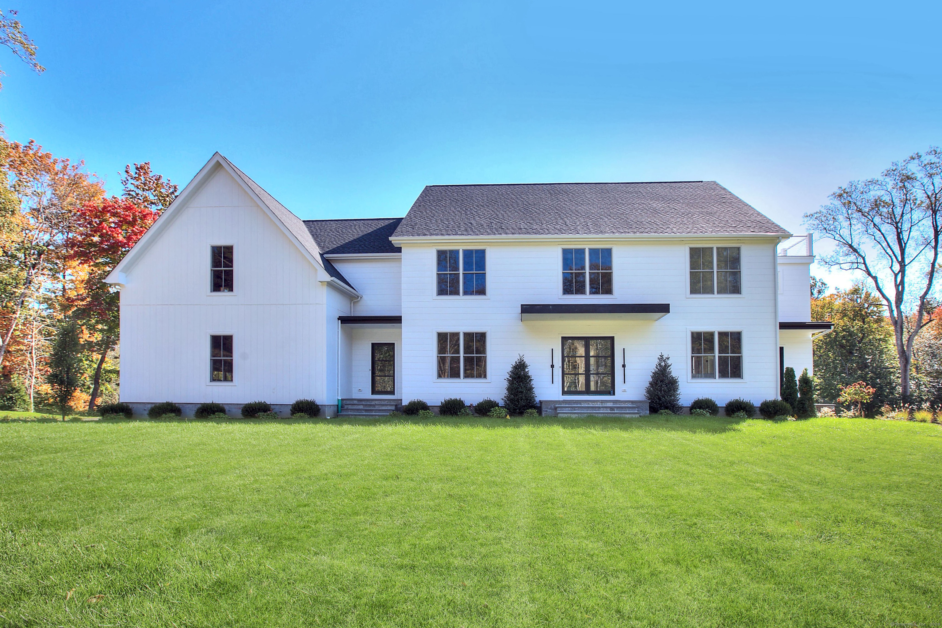 Professionally curated new home with a clean aesthetic incorporating the latest design ideas and finest materials. The crisp look of nickel-gap siding from the JamesHardie Aspyre Collection complimented by large Marvin windows and doors welcome you. Walking through the first floor you'll see spaces perfect for both entertaining and casual living blended together on beautiful white oak flooring. Top-of-line Thermador appliances will catch your eye in the kitchen as will the walk-in pantry and scullery leading to a spacious dining room. Bathed in natural light, the open kitchen family room space is a wonderful place to cook, eat and live. Before looking upstairs don't miss the first-floor office with an adjacent bar area and private patio. Once upstairs, the primary bedroom steals the show. Bright and airy with oak beams, a cozy fireplace, enormous closet space and a super luxurious bath including a shower room with two shower set ups and comfy soaking tub...you'll never want to leave! Two ensuite bedrooms plus a Jack and Jill bedroom with connecting bath round out the second level. The third floor could be an amazing teen-suite or an equally wonderful office suite with full bath and viewing deck area overlooking conservation land. Completing four finished levels is the lower-level family room, bedroom and cabana bathroom leading to a stunning Signature Pool sited on .71 acres at the end of a quiet cul-de-sac, centrally located near all Westport amenities