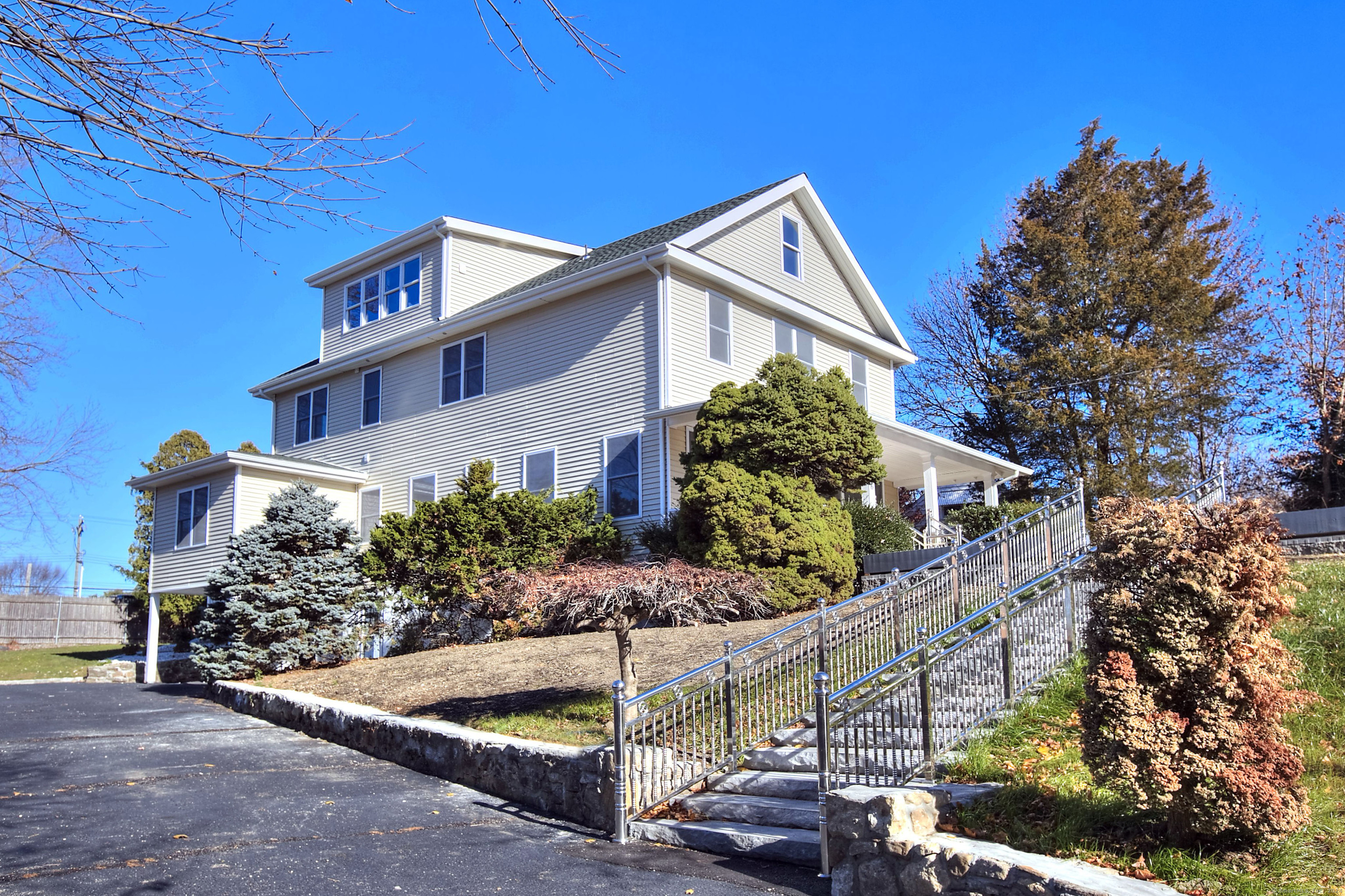 Located in Southport's highly desirable neighborhood, this renovated colonial home on 0.32 acres, has four levels of exceptional living space. Designed with an open floor plan, abundant natural light, and beautiful hardwood floors throughout, the property is ideal for modern day living. A stone staircase leads to a charming bluestone patio and covered porch, creating an inviting entry where modern comforts meet timeless character. Inside, the thoughtfully planned layout allows for effortless flow between rooms, making it perfect for everyday living and entertainment. The bright, contemporary kitchen impresses with high-end stainless-steel appliances, marble tile, custom cabinetry, and a spacious island with seating is an ideal gathering spot for family and friends. Additional features include a mudroom and space to finish a butler's pantry. The open and airy living room, framed by large windows and polished hardwood floors, provides a relaxing and welcoming space. The primary bedroom suite is a private retreat, featuring a walk-in closet and a spa-inspired bathroom with a glass-enclosed shower, and dual vanities. Additional bedrooms and versatile third-floor space can easily function as home offices, play areas or exercise room. High-quality finishes, including marble accents, recessed lighting, and elegant fixtures, enhance the home's timeless appeal. The outdoor area has a spacious patio ideal for entertaining, and a fenced backyard that provides privacy.