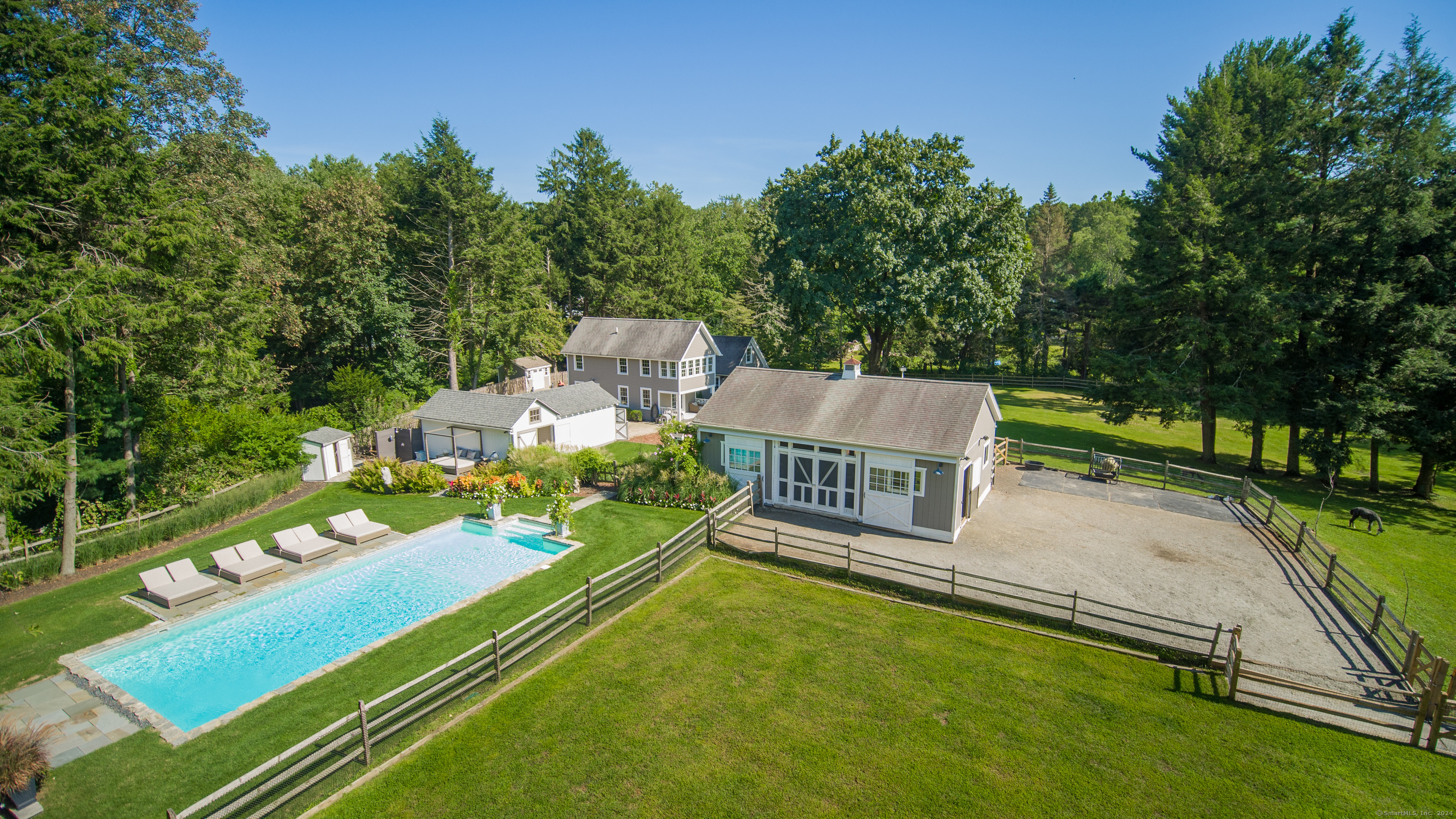 Embrace the tranquility of this exceptional equestrian estate, nestled on 4.45 acres of private beautiful land. This serene property is a haven for horse and animal lovers, featuring expansive pastures, barn, stable, paddocks and sand riding ring. This one-of-a-kind property borders the Aspetuck Land Trust, offering unmatched natural beauty and privacy. The renovated antique farmhouse exudes charm, with many gathering spaces on the main level and a private office. The views of the property from the farmhouse are simply wonderful. There are two bedrooms and additional rooms on the upper level, allowing flexible living with excellent space. The primary suite is lovely and includes a lounge area with a bird's-eye-view of the property. Indulge in the luxury of a private saltwater pool with outdoor rain shower with deck - perfect for relaxation. Dine outdoors on the bluestone patio at the rear of the property or enjoy a quiet morning on the front patio. This home could be a fabulous full-time or weekend home. The property is a rare find in coastal Connecticut, offering a peaceful and beautiful equestrian lifestyle, just minutes to beaches, transportation, restaurants and all of Southport/Fairfield's cherished amenities.