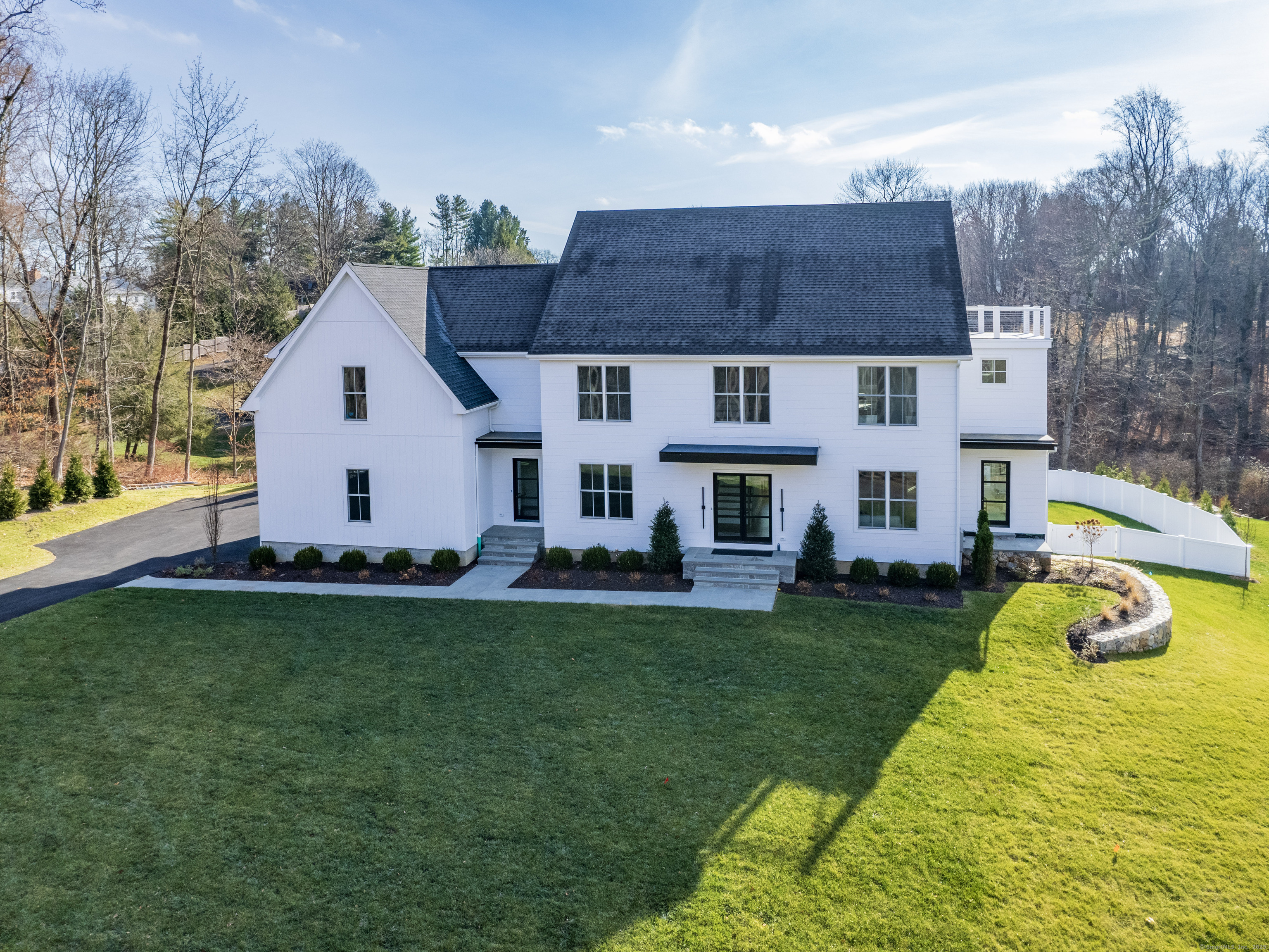 Professionally curated new home with a clean aesthetic incorporating the latest design ideas and finest materials. The crisp look of nickel-gap siding from the JamesHardie Aspyre Collection complimented by large Marvin windows and doors welcome you. Walking through the first floor you'll see spaces perfect for both entertaining and casual living blended together on beautiful white oak flooring. Top-of-line Thermador appliances will catch your eye in the kitchen as will the walk-in pantry and scullery leading to a spacious dining room. Bathed in natural light, the open kitchen family room space is a wonderful place to cook, eat and live. Before looking upstairs don't miss the first-floor office with an adjacent bar area and private patio. Once upstairs, the primary bedroom steals the show. Bright and airy with oak beams, a cozy fireplace, enormous closet space and a super luxurious bath including a shower room with two shower set ups and comfy soaking tub...you'll never want to leave! Two ensuite bedrooms plus a Jack and Jill bedroom with connecting bath round out the second level. The third floor could be an amazing teen-suite or an equally wonderful office suite with full bath and viewing deck area overlooking conservation land. Completing four finished levels is the lower-level family room, bedroom and cabana bathroom leading to a stunning Signature Pool sited on .71 acres at the end of a quiet cul-de-sac, centrally located near all Westport amenities