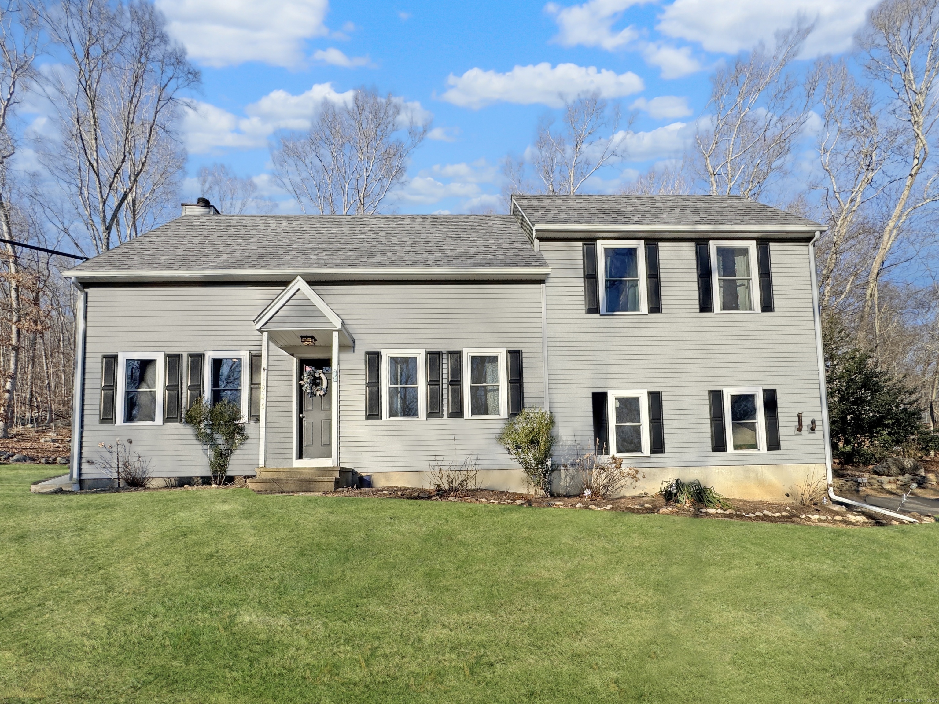 Nestled near the Killingworth/Madison town line, this beautifully updated Cape Cod home blends modern comforts with timeless charm. Expanded in 2021, this spacious 4 bedroom residence has been thoughtfully renovated, featuring all new windows and slider door, new vinyl siding, a renovated kitchen, and updated bathrooms. The freshly painted main level boasts hardwood floors throughout, with an open and inviting floor plan that includes both a formal dining room and a large family room. The bright breakfast area is complemented by a new pellet stove with a striking stone surround, providing efficient warmth for the entire home. A convenient half bath and first-floor laundry add to the ease of living. Upstairs, four generously sized bedrooms offer ample space with an additional 5th bedroom option or office. The primary suite with hardwood floors includes a private bath, while the other three bedrooms share a well-appointed hallway bathroom. The home also features a newly installed well neutralizing system, ensuring peace of mind. Set on two private acres, the backyard was also enhanced and offers a new 20x20 ground level Trex deck with a gorgeous stone wall surround, perfect for entertaining or simply relaxing. This home delivers the ideal balance of style, comfort, and convenience. Professional photos will be available on Saturday.