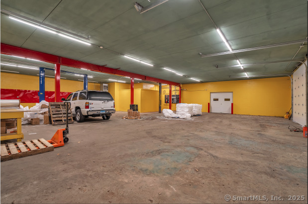 Versatile warehouse space this 3, 960 sq. ft. unit (60' wide x 66' deep) features two oversized exterior overhead doors (14' wide x 10.8' high), a 10, 000-lb car lift installed in 2024, and 11.8' ceiling height. Additional amenities include LED motion-activated lighting, forced hot air propane heating, a private office with a mechanic sink, and handicap-accessible men's and ladies' bathrooms. The space also boasts a durable EPDM roof installed in 2020. Ideal for automotive, storage, or operational needs, this well-equipped building is conveniently located near Route 80.