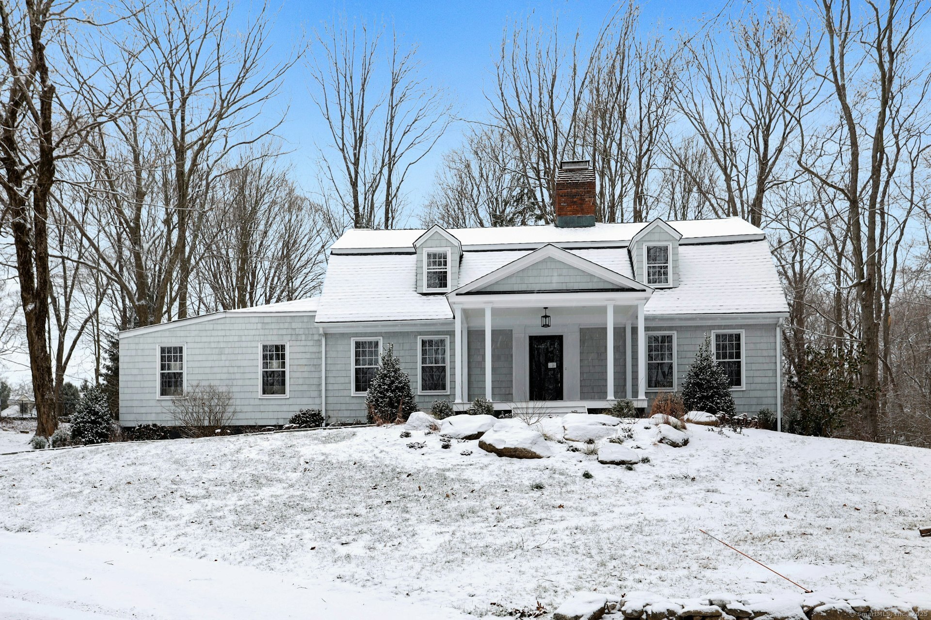 Welcome to 55 Silver Hill Road, an expanded Cape Cod-style home in Ridgefield, CT. This meticulously updated residence features 2, 847 sq ft of elegant living space, with four spacious bedrooms and two and a half bathrooms. Gleaming hardwood floors enhance the home's timeless appeal. Freshly painted inside and out, it features a charming new front porch and a brand-new roof. The kitchen dazzles with new appliances, granite countertops, an island, and a skylight seamlessly flowing into the comfortable dining room-perfect for entertaining. The sunlit family room feels like a serene retreat, ideal for reading or as a playroom. A private home office with French doors enhances functionality and privacy. The home features two primary bedrooms-one on the first floor and another upstairs-plus two additional bedrooms. The luxurious upstairs bath includes a soaking tub and a large shower stall. A new stackable washer/dryer in the first-floor powder room adds convenience. Set on a private 2-acre lot, the property invites outdoor enjoyment with a spacious patio. The 1, 400 sq ft unfinished basement provides customization potential, and the large detached garage provides ample storage. Experience Ridgefield's vibrant lifestyle, renowned for top-rated schools, art galleries, music venues, and exceptional dining. Recognized for safety and cultural richness, Ridgefield provides an unparalleled life style. Do not miss this opportunity to make this remarkable home and community your own.