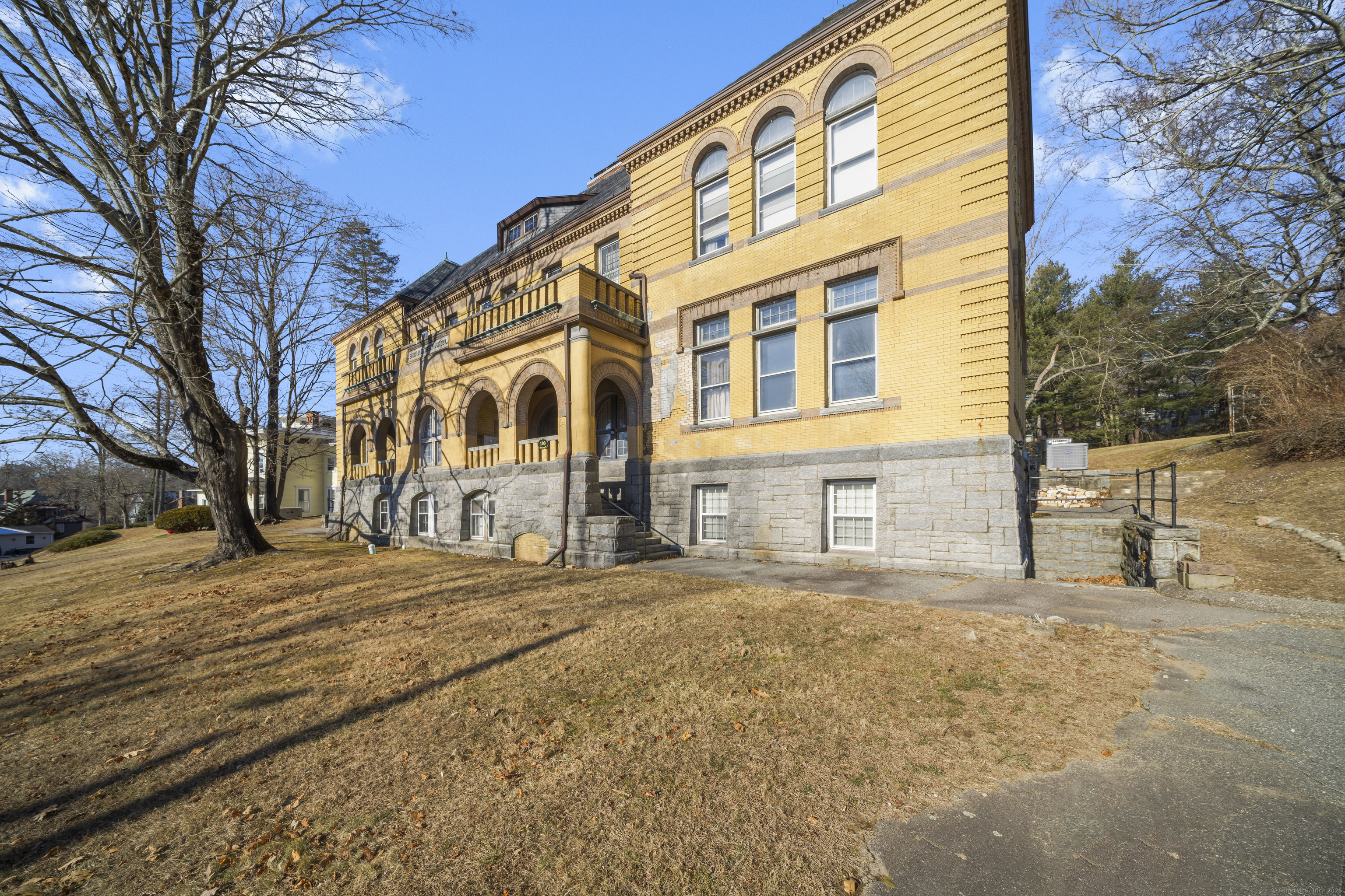 **Own a Piece of History**  Discover this stunning condo in the iconic Historic Broad Street School, designed by renowned architect Wilson Potter in 1897. Renovated into condo's in 1983 and listed on the National Register of Historic Places in 1984. This main-floor unit offers convenient SINGLE LEVEL LIVING with 2 bedrooms and 1 bathroom. Enjoy FAN-FORCED HEATING and CENTRAL AIR for year-round comfort. The condo features historic charm with TALL CEILINGS, expansive windows, and original doorways with transom windows. The kitchen boasts GRANITE and a pass-through to the open living and dining areas, perfect for entertaining or relaxing. The bathroom is accessible from both the hall and the primary bedroom for added convenience. This unique building has just 10 units and includes a shared laundry room conveniently located on the main level, only two doors down from the unit. Less than .25 miles to Mohegan Park. Will NOT go Gov Financing. CASH or Conventional only. HOA fee is $394.56, Special Assessment is $237.04 a month for 15 years, started Nov 2024. Total monthly fee is $632.