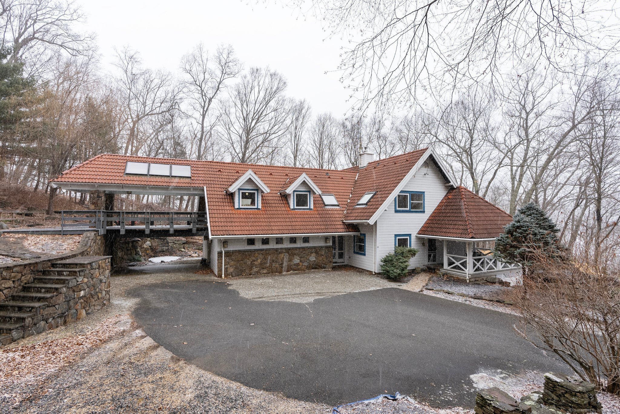 Welcome to this stunning zero-energy hilltop retreat in the heart of Sharon, Connecticut, built by Denmark-based Trelleborg. Nestled on over 13 acres (and including a .4 acre lot on Mudge Pond), this 4-bedroom, 3.0 bath (town card says 3BR 2.5BA but is wrong) contemporary Spanish-tiled cape home offers a tranquil escape with breathtaking views and Japanese gardens amongst unprecedented seclusion. Upon entering, you're greeted by an open-concept living space that features natural pine ceilings, hardwood floors throughout, luxurious upholstered walls, and floor-to-ceiling windows that allow natural light to flood the home and highlight the serene landscape. The spacious first floor includes a gourmet kitchen with granite countertops, stainless steel appliances, and custom cabinetry flows seamlessly into a dining area with cathedral ceilings and a wood burning stove, perfect for relaxing on chilly evenings. Rounding out the first floor is a breathtaking 2-story library wing, perfect for large parties or quiet evenings with a book. Upstairs, the primary suite is a private haven, with two walk-in closets and a spa-like ensuite bathroom with a soaking tub and separate shower. Two additional bedrooms upstairs are generously sized, and there is a 4th bedroom on the main level. Step outside onto the expansive patio - a gardeners dream dotted with exotic plantings and framed by elaborate landscaped stonework in a peaceful, nature-filled setting. Schedule your private showing today.