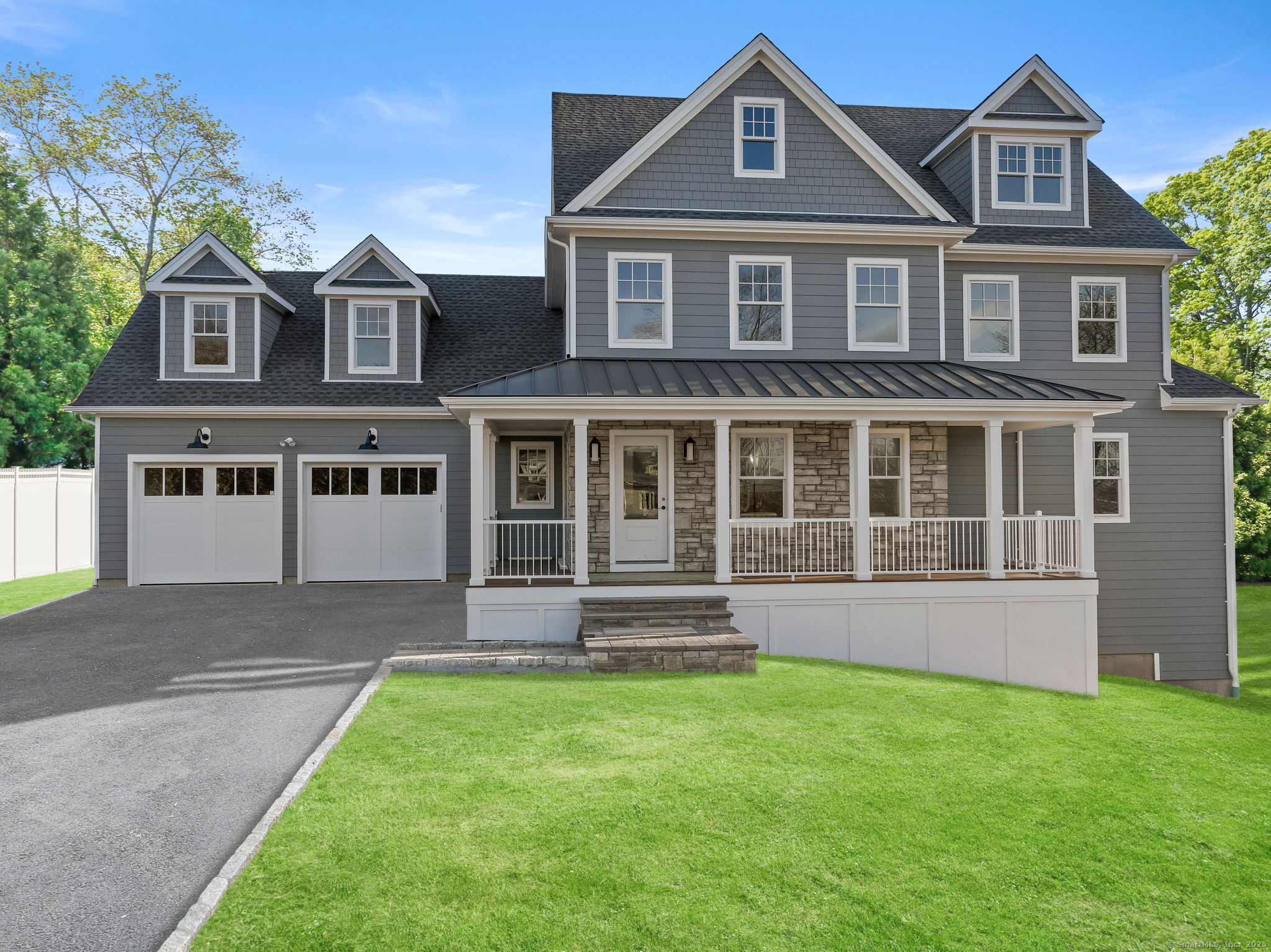 Perched on an expansive property with wraparound porch, beautiful stonework & arborvitae, enjoy sweeping views across the sought-after Lake Area & easy access to the best lifestyle features in Fairfield. This exquisite new home has been thoughtfully designed by local, HOBI Award-winning builders to offer both space & sophistication, with a timeless style & refreshingly unique floorplan. The magazine-worthy Kitchen, Dining & Family Room combine to create an airy, sunlit Great Room that is the true heart of this home. Enjoy Thermador appliances & 48 range with custom hood, natural oak island & accents, quartz countertops, designer backsplash, & walk-in pantry with shelving (& 2nd W/D hookup). Cuddle up with loved ones in front of the stone fireplace in the Family Room, and enjoy Sunday breakfast in the dining area surrounded by oversized windows. Massive glass doors spill onto the grilling patio & sprawling rear yard (perfect spot for a pool!). The FlexRoom can adapt to your needs: Formal Dining, Living, Office, or Playroom. The serene Primary Wing includes a dressing room & zen-like SpaBath with custom vanity, freestanding tub, & shower with frameless glass, quartz bench seat, porcelain tile surround, & high-end Kohler shower system. The two-car garage is well-proportioned with just a few steps into a functional Drop Zone with bench, cubbies, coat closet & Powder Room. Upstairs, find three additional bedrooms & two full bathrooms, including a Guest Suite with (continued)