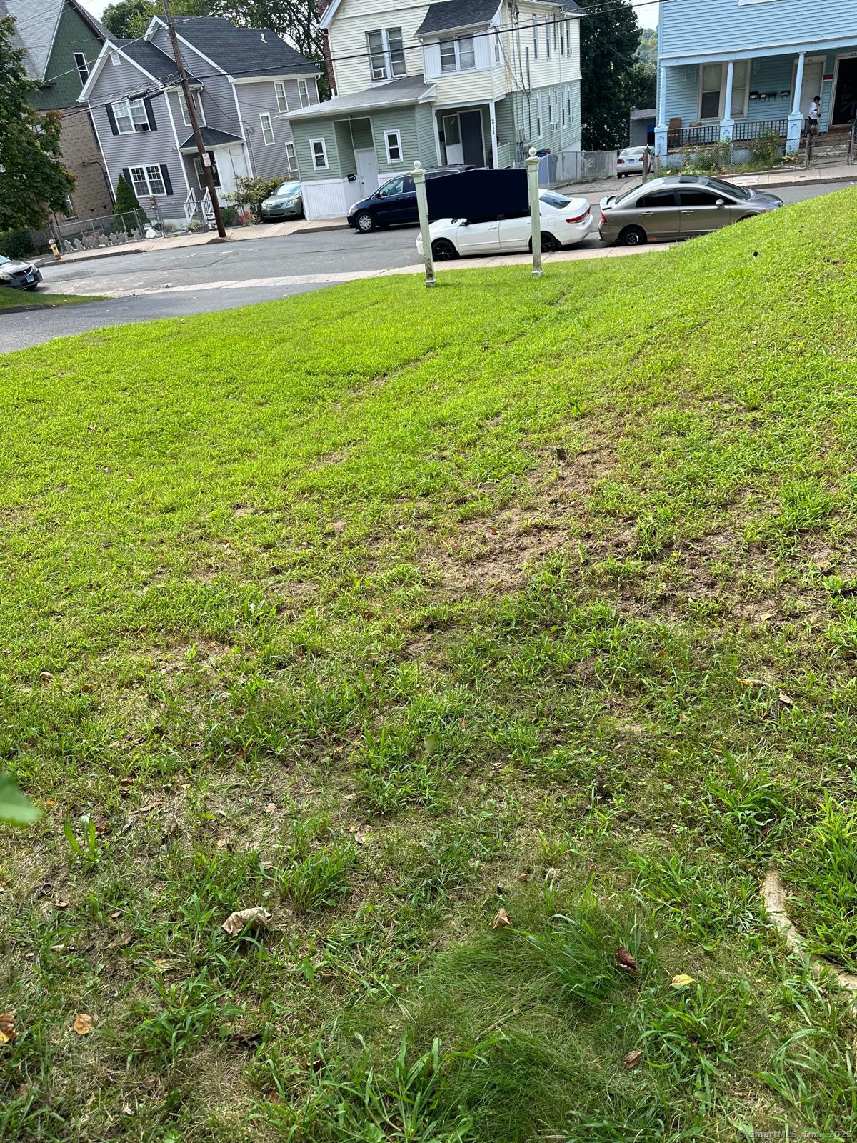 Cleared lot in neighborhood. Lot is an approved non-conforming building lot for a single family house. Water and sewer shut off at street.