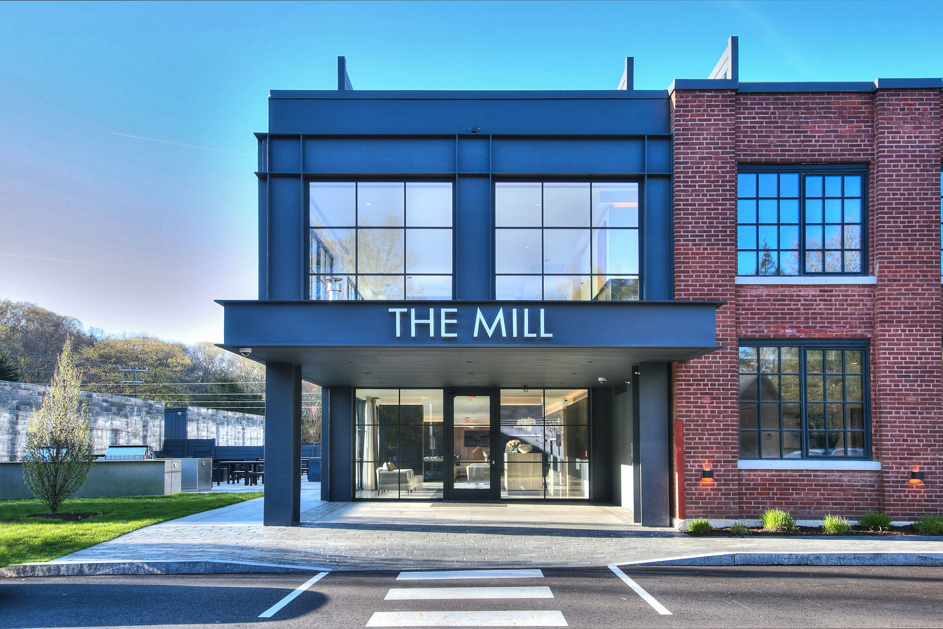 The Mill Westport offers high-end luxury living with all the amenities of a fine custom home in the heart of downtown Westport. With a concierge on-site and approximately 10,000 square feet of spectacular interior and exterior amenity spaces such as The Great Room & Cafe, Pool, Health & Wellness Center, Patio & Rooftop Deck, residents will enjoy carefree, 5-star living. The 31 residences feature large windows, open floor plans, and light wood floors. Their refined details include a large waterfall-edged kitchen island, linear gas fireplaces, Sub Zero and Wolf appliances, full-size washer/dryers, and up-to-date bathrooms with radiant heated master bath floors. A variety of floor plans are available to meet the unique needs of discerning buyers seeking a bespoke lifestyle, with some offering spectacular terraces. All homeowners have access to heated or covered parking. Set in a tranquil, residential neighborhood within walking distance of downtown Westport’s many shops, restaurants, activities and close to beaches and commuting options to New York City. The redevelopment and adaptation of The Mill Westport into a luxurious residential property is being undertaken by Coastal Luxury Homes and Gault Family Companies, two Westport-based firms with a proven track record of surpassing the highest expectations. All property images are artist renderings. Depicted characteristics are subject to change.