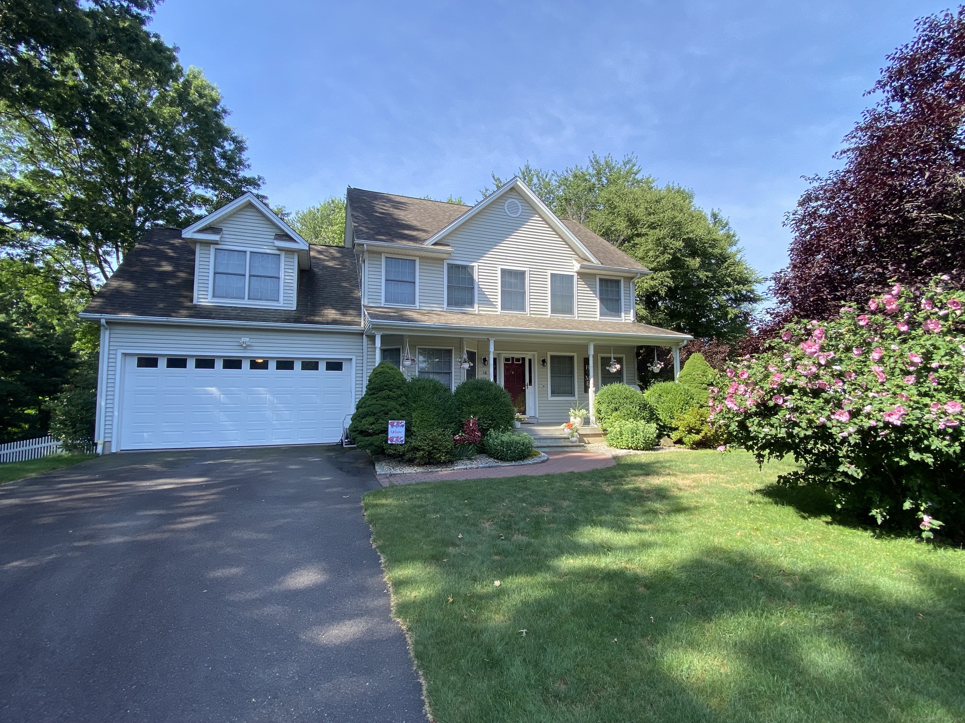 Welcome to your dream home! This stunning 3 BR Colonial is perfectly situated at the end of a serene cul-de-sac, offering privacy and picturesque surroundings on a beautifully manicured 1.1-acre lot. Step onto the charming covered front porch and into this warm, inviting home, where hardwood floors flow throughout. The spacious living room boasts a cozy gas fireplace and opens seamlessly to the kitchen and a lovely back deck, creating a perfect space for entertaining and relaxation.The EIK is a chef's delight, featuring cherry cabinets, granite countertops, a stylish glass backsplash, stainless steel appliances, a gas range, a central island, a breakfast bar, and a delightful built-in bay seating area with storage. The formal dining room is elegant and timeless, with a bay window, chair rail, and crown molding. A convenient main-level laundry room and a half bath complete the first floor. Upstairs, the primary bedroom suite is a luxurious retreat with a walk-in closet and a spa-like full bath, complete with a whirlpool tub. Two additional bedrooms offer generous space, one featuring its own walk-in closet and full bath. The versatile great room is ideal for a home office, a fourth bedroom, a playroom, or a home gym. The beautifully finished lower level provides additional living space with a walkout to the backyard, perfect for gatherings or quiet moments. The outdoor oasis includes a deck overlooking a patio, gardens, and a handy shed.