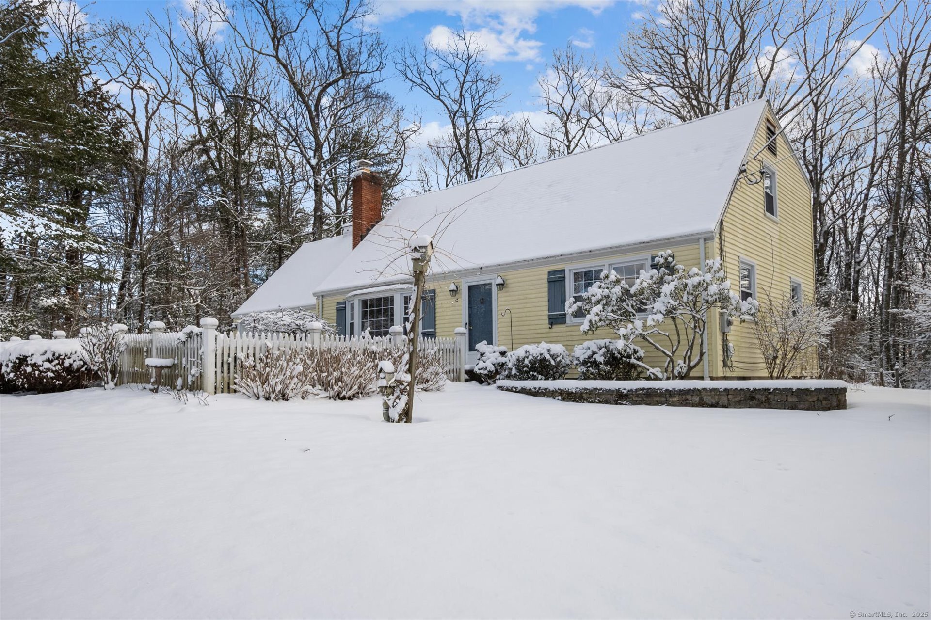 Nestled in a tranquil neighborhood, this charming sunny yellow Cape Cod home is a true gem. Surrounded by beautifully enchanting gardens and a fenced courtyard, it offers a serene atmosphere with peek-a-boo seasonal views of the stunning Talcott Mountain. Inside, warm wood floors flow throughout, creating a welcoming ambiance. The updated kitchen features sleek granite counters and a tiled dining area/sunroom, which opens up to a deck with a lovely pergola - perfect for relaxing or entertaining. The formal dining and living rooms are equally inviting, with a cozy fireplace adding to the charm. On the first floor, you'll find a bedroom and a full bath, along with a study ideal for work or leisure. Upstairs, the spacious primary bedroom is complemented by several closets, and two additional bedrooms and a full bath complete this level. Recent updates, including replacement windows, a 2014 furnace, and a Boiler Mate hot water system, add comfort and efficiency to this home. It's a peaceful retreat with modern touches and timeless appeal. Being sold as is and quick occupancy is possible.