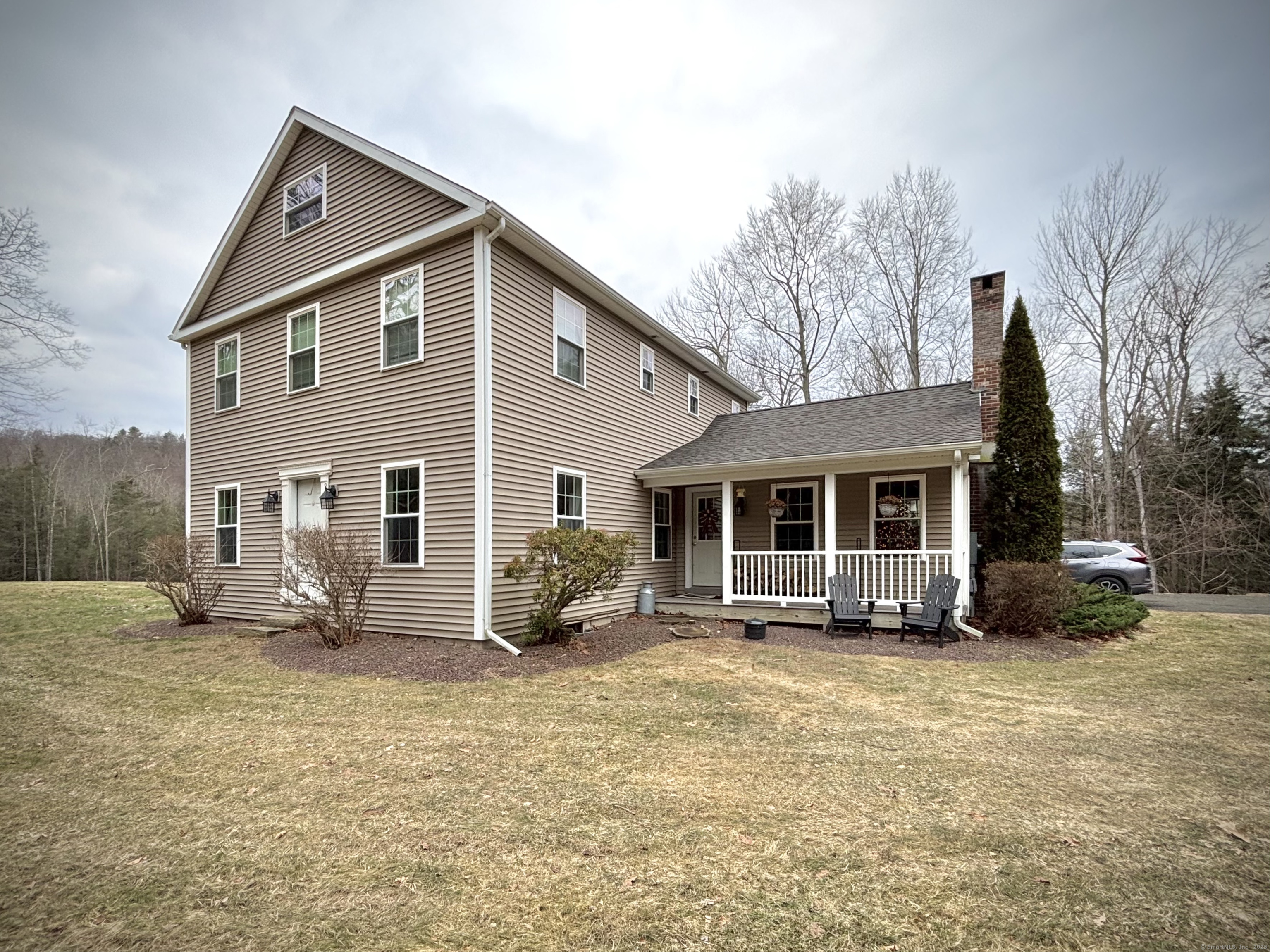 Don't miss this 3 bedroom 2 1/2 bath Colonial situated on a private 5 acre lot! Open floor plan, wide board flooring, and tons of character and charm. Large kitchen and dining area with plenty of room for gatherings - center island, fireplace, and access to an oversized two tier composite deck. The family room offers cathedral ceilings, a wood stove fireplace, and access to an outdoor porch. Main level with laundry, half bath, and two versatile additional rooms - which could be used as another dining room, living room or perfect for an office and playroom. Upper level you will find a spacious primary bedroom, two bedrooms, and a full bathroom. The primary bedroom has its own full bathroom with double sinks, fireplace, walk-in closet, and a walk-up attic. Lower level with 9+ ceilings, walk-out double doors, plenty of storage and tons of potential for making even more finished livable space! High efficiency on demand propane boiler (2024), newer black stainless appliances, updated light fixtures throughout, PLUS an oversized attached 2 car garage with additional upper storage space.