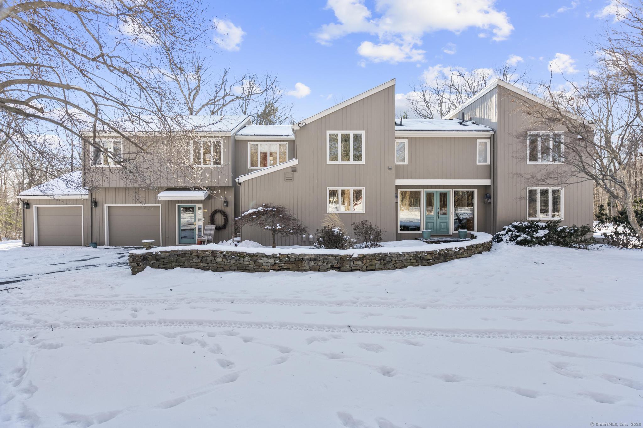 Welcome to 90 Highridge Road! This gorgeous light and bright West Simsbury contemporary offers too many special features to list! Located on five level and tranquil acres, this home has a beautiful chef's kitchen with honed granite counter tops, a butcher block center island with a wet bar, a six burner gas stove, wide plank flooring and gorgeous custom cabinetry. The dining room has wide plank floors as well as a field stone double sided fireplace. The family room has vaulted ceilings, a floor to ceiling double sided fireplace, wide plank flooring and enters out to a gorgeous oversized screened in porch. The screened in porch is a wonderful addition to this home and lends itself to great entertaining options as your guests over look the beautiful rear yard. The first floor also has a living room, study/office and a first floor bathroom. The second floor has five bedrooms, three full bathrooms and a half walled hallway overlooking the beautiful family room. The primary bathroom has been completely renovated and has electric/ radiant heat under the beautiful marble flooring. There is a built in armoire in the hallway for additional closet space. One of the bedrooms is being used as a laundry room but there are laundry hookups in the basement as well. The partially finished lower level offers additional living area with another fireplace and a tremendous amount of storage. There is a also a full house generator that is staying with the home. This is truly a spectacular home.