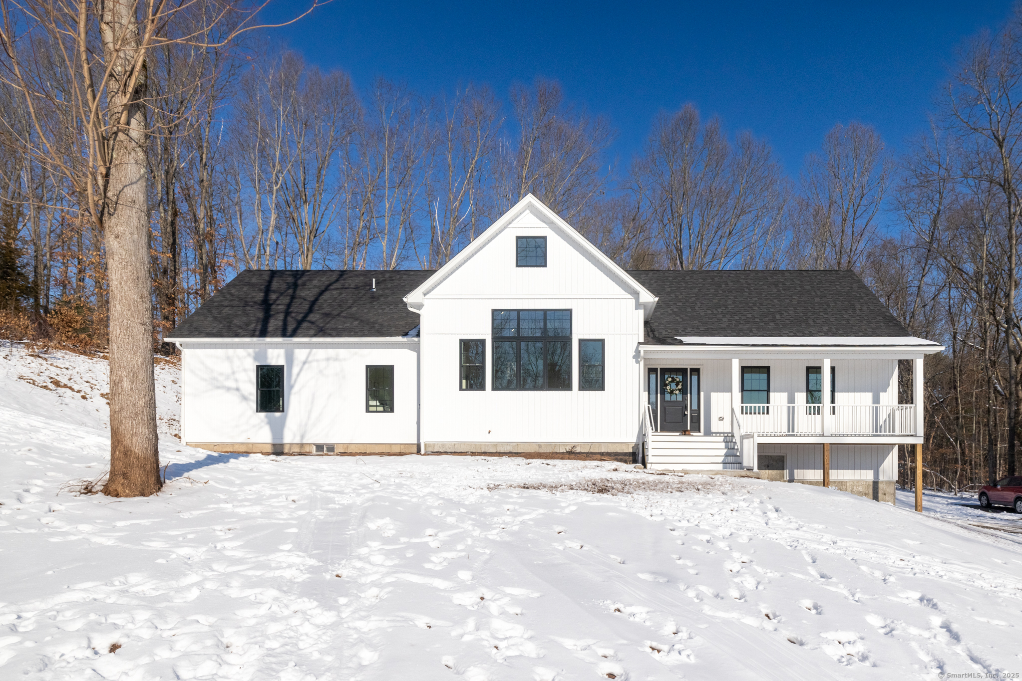 Welcome to this stunning contemporary ranch-style new build, offering 3 bedrooms, 2 full baths, and 2, 071 square feet of modern living space. Situated on a private lot just minutes from downtown Glastonbury, this new build features an open floor plan with 22-foot cathedral ceilings, exposed beams, and ample natural light from two-story windows. The spacious kitchen, living, and dining areas seamlessly flow together, perfect for entertaining. The large primary suite boasts a massive walk-in closet and a luxurious bathroom with an oversized tile shower with dual shower heads. Additional highlights include a gas fireplace, ceiling fans, and 3 exterior decks. A 2-car garage completes this exceptional home. The expansive basement offers the potential for additional living space, allowing the new owner to finish it to suit their needs.