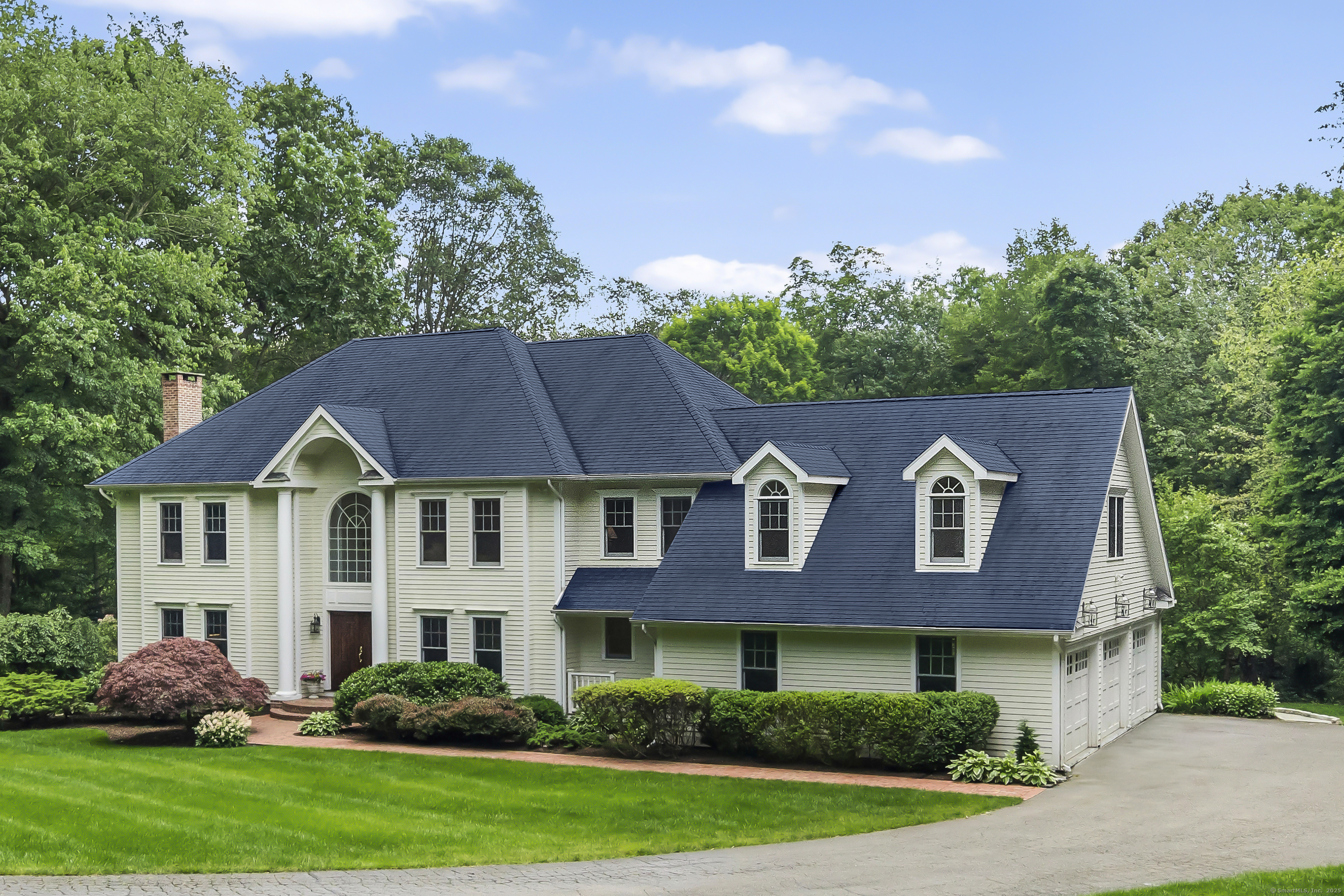 Discover luxury and privacy at this stunning colonial on prestigious Ponus Ridge. Set on 2.2 lush acres with perennial gardens and bordering conservation land, this west-side oasis is minutes from town, trains, and West Elementary School. Move-in ready with a new roof, renovated bathrooms, freshly painted interiors, and meticulous mechanicals, this home blends elegance with modern convenience. The grand two-story foyer with custom millwork throughout leads to gorgeous living spaces, including a living room with a marble mahogany fireplace, a formal dining room with a wet bar, and a family room featuring a cathedral ceiling, fieldstone fireplace, and a wall of windows showcasing the tranquil backyard. The chef's kitchen is a dream, offering Sub-Zero, Bosch, and Miele appliances, an oversized island, a walk-in pantry, and a sunny dining area with deck access. A screened three-season porch with vaulted ceilings, exposed beams, and mahogany floors is perfect for enjoying indoor-outdoor living. The luxurious primary suite boasts a spa-like bath and three walk-in closets. Four additional bedrooms, updated bathrooms, and an au pair/in-law suite with private stairway complete the upper level. The walk-out lower level offers versatility with a great room, gym, second office, half bath, and storage. Outside, relax or entertain on the expansive deck, slate patio or around the firepit, all while enjoying unmatched privacy. This estate is a rare blend of luxury, privacy, and convienence!