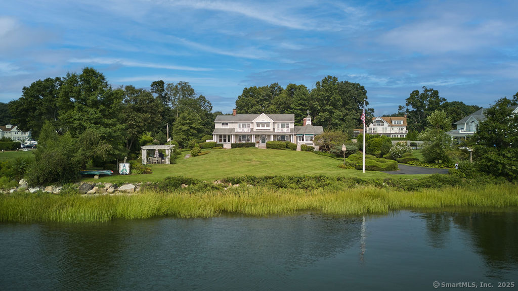 175 ft of direct Westport waterfront.For the first time in over 50 years, this unmatched harborside home set on over an acre is ready to be enjoyed by new residents.Beautifully sited on Saugatuck Harbor, this classic four bedroom Colonial with a wrap around porch holds 4000 +sqft of living space that spills out to the most picturesque property on all sides! The harbor to the front, the Saugatuck Yacht club to one side, a private and level backyard, and just a quick stroll over to the community beachfront area to the other side.The main level consists of a front to back great room, with a cottage style rotunda breakfast nook overlooking the water, a bright and spacious kitchen with center island and a warm and welcoming family room anchored by a river rock fireplace.There are formal living and dining rooms, a handsome office, a butler's pantry, oversized laundry room, a half bath and even a greenhouse by the rear facing deck! Upstairs, the primary suite has a water facing bedroom with a peaceful balcony, a large bath w shower, tub and water closet, a bonus landing space w secondary stairs to the first fl office and double closets. Three family bedrooms and 2 full baths complete the upper level. There is a full LL with walk out to the backyard featuring a rec room, and plenty of storage. The three car garage & private driveway offers plenty of room for guests! The rolling front lawn is home to a party pavilion, perfect for gathering with friends and family to enjoy the sunsets!