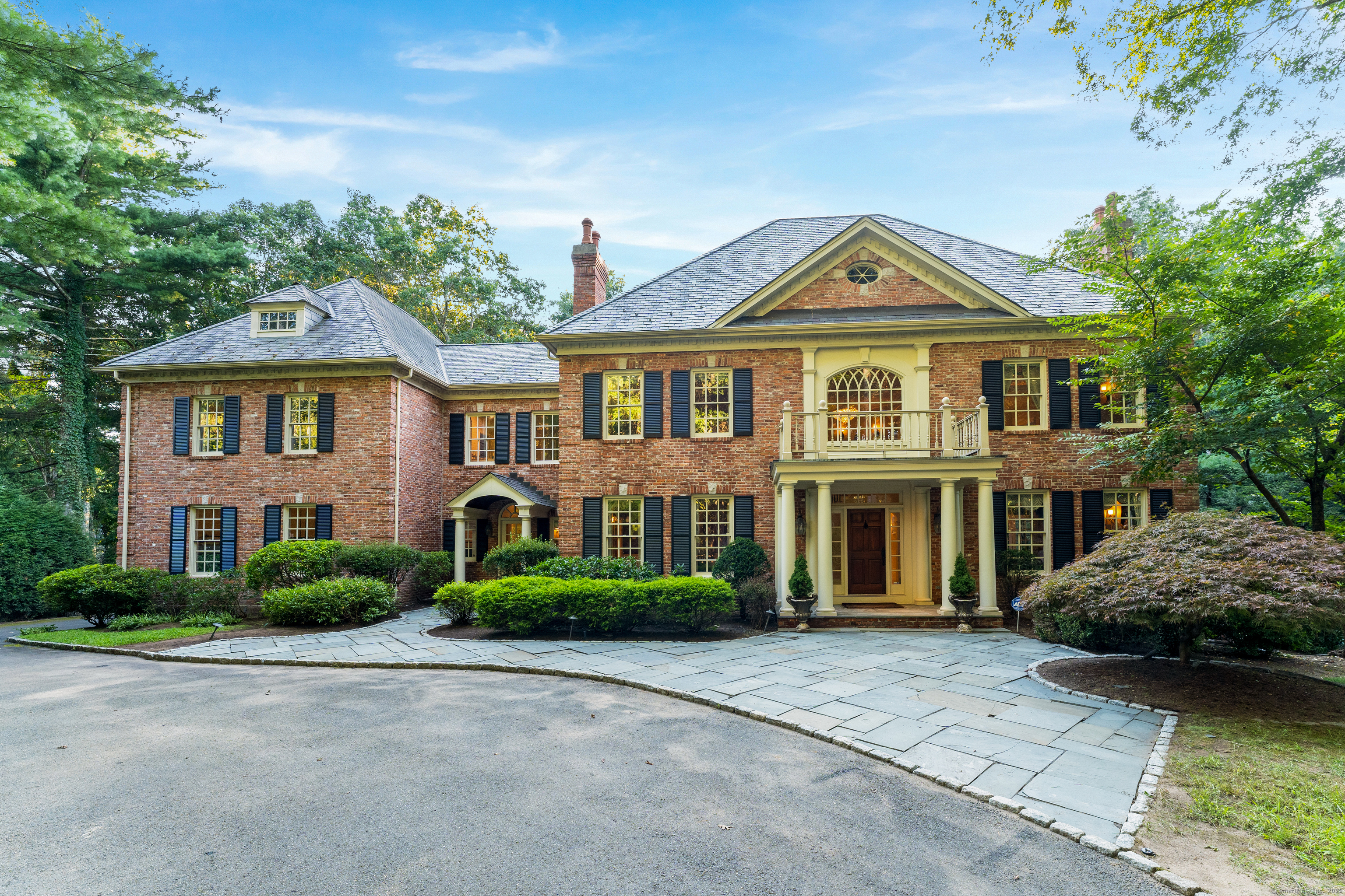 This luxurious 5-bedroom, 5-full bath and 2 half-bath home is tucked away in the highly sought after neighborhood of Devonwood. A masterpiece of design, this stunning brick home features a slate roof, gunite pool and spa with sweeping views of the private and peaceful wooded backyard. The impressive two-story foyer with a graceful curved staircase, exquisite millwork, hardwood floors throughout and 10-foot ceilings enhanced by fresh paint, every inch of this residence exudes sophistication and comfort. The living room flows into a cherry wood study that overlooks the lush backyard. The dining room with FP and butler's pantry leads to the large kitchen which opens to the family room w/coffered ceiling, FP, 2 story double-stacked windows, this space is bathed in natural light and perfect for large gatherings. You will find the sizable main bdrm on the 2nd floor w/ FP, serene sitting room and large walk in closet. The main bath w/soaking tub, dual sinks, large shower w/dual shower heads and his/her water closets. Down the hall are 4 bdrms, one ensuite and one Jack and Jill, the 5th bdrm is currently used as an exercise room. The walkout lower level is the epitome of entertainment, featuring a FP, wet bar, home theater, full bath w/steam shower, new carpet and paint. It opens to the sparkling gunite pool and spa, exquisite bluestone patios provide an idyllic setting for outdoor living and entertaining. This exceptional home is more than just a place to live - it's a lifestyle