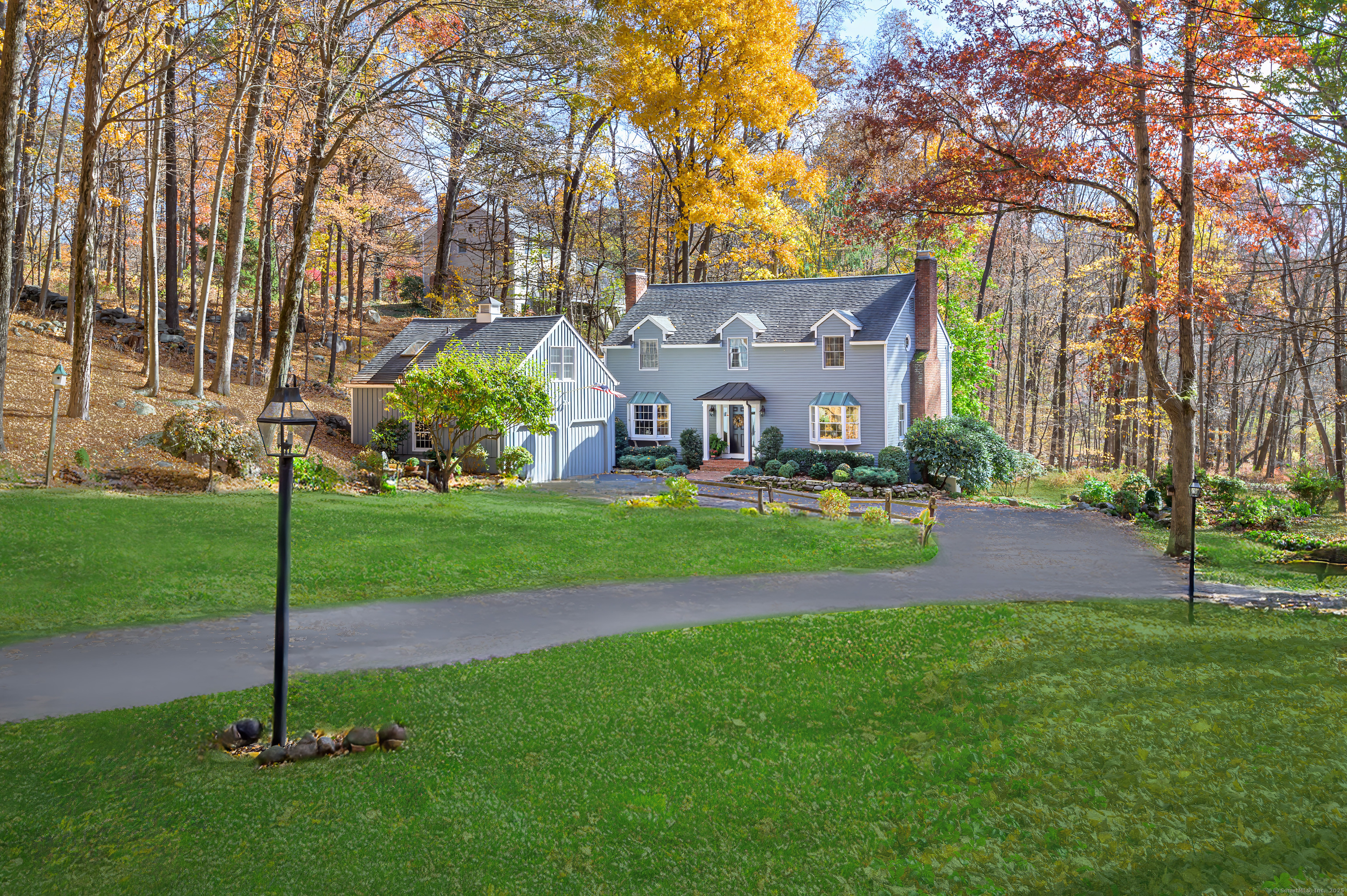 Welcome to 135 Indian Cave Road, a picture-perfect New England Colonial beautifully sited on a serene cul-de-sac in one of South Ridgefield's most desirable neighborhoods. This charming home spanning 3, 230 square feet has a timeless vibe with classic detailing and perfectly scaled rooms. Step into the brick foyer and be greeted by a front-to-back Living Rm featuring a cozy fireplace, ideal for gatherings. An Inviting Dining Rm leads to a large KIT with light filled breakfast area that opens onto an expansive deck, offering beautiful views of the natural surroundings. Adjacent to the KIT, discover a fabulous Family Rm adorned with barn wood paneling, vaulted ceiling, custom built-ins, and a striking floor-to-ceiling brick fireplace. Continue into the sunlit Sunroom, perfect for year round relaxation. The upper level boasts a spacious Primary Suite with fireplace, walk-in closet & full bath, plus an adjoining room for optional Office, Nursery, or create a fabulous Dressing Rm. Two well-sized BR's + full bath complete this level. A separate guest suite with own entrance and full bath provides an added bonus. Finished, walk-out lower level invites many possibilities. Set on 2.33 sprawling acres, this property allows for privacy & plenty of room to explore. Experience the unique charm of Ridgefield with one of Fairfield County's best downtown destinations - deemed CT's First Cultural District. Enjoy a sporty lifestyle as well. Approx. 1 HR to NYC. Award Winning Schools!