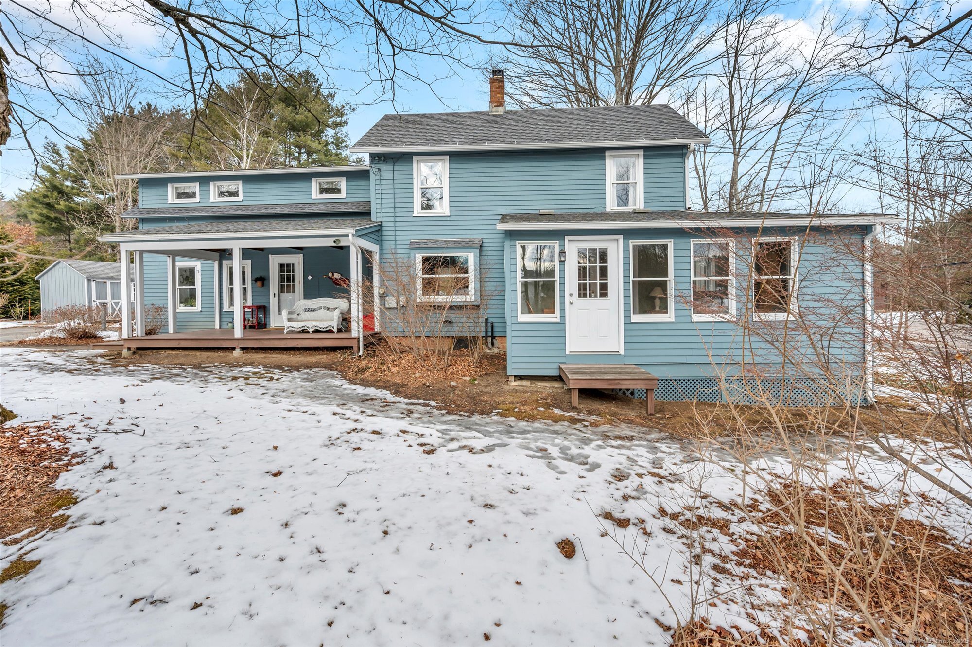 Step into the charm of this beautifully maintained early 20th-century farmhouse at 2 Kelly Lane, Granby, CT! This inviting 3-bedroom, 1.5-bath colonial offers a spacious eat-in kitchen with ample cabinets, generous counter space, and a full walk-in pantry. The first-floor laundry adds convenience, while the living room boasts hardwood floors and French doors leading to a heated enclosed sunroom. A bay window and woodstove enhance the warmth of the dining room. The primary suite includes a private half bath, and the home features three heating zones, double-insulated vinyl windows, and a sunroom with its own heating zone. Recent updates include a new roof (2019), exterior paint (2019), dishwasher (2021), electrical updates (2022), attic insulation (2022), new kitchen sink window (2023), new washing machine (2023), and a new sediment filter (2024). The main entry porch converts to a full-screened porch for seasonal enjoyment. Situated on a level corner lot, with an 8x10 Shed for additional storage, this home offers easy access to Granby Center, shopping, schools, and Bradley International Airport. A perfect blend of historic charm and modern updates-don't miss this one!