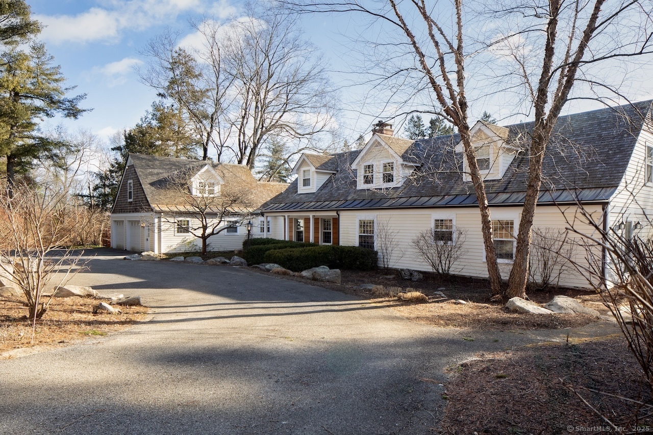 Charming Home With Artist Studio And Pond Views - Nestled on the picturesque Belgo Road, this charming 1890 home is beautifully set amidst mature trees, vibrant gardens, stone patios, and winding walkways. Meticulously restored to preserve its historic character, the property seamlessly integrates modern amenities for today's lifestyle. The heart of the home features a dining area and kitchen with vaulted ceilings and antique beams, while the adjoining living room, with its fireplace and paneled walls, exudes timeless charm. The residence boasts five uniquely designed bedrooms, each with its own ensuite bath, including a main-floor primary suite for ultimate convenience. A separate studio adds versatility to the property, perfectly situated in an open field. A serene pond and meandering stream enhance the idyllic 6-acre country setting, just minutes from town and nearby renowned prep schools. This is a rare opportunity to own a piece of history with all the comforts of modern living. Ideally located near the many private & public schools, Catamount Ski Area and Aerial Park, and the villages of Salisbury, CT, Millerton, NY, Great Barrington, MA, and Wassaic Train Station.