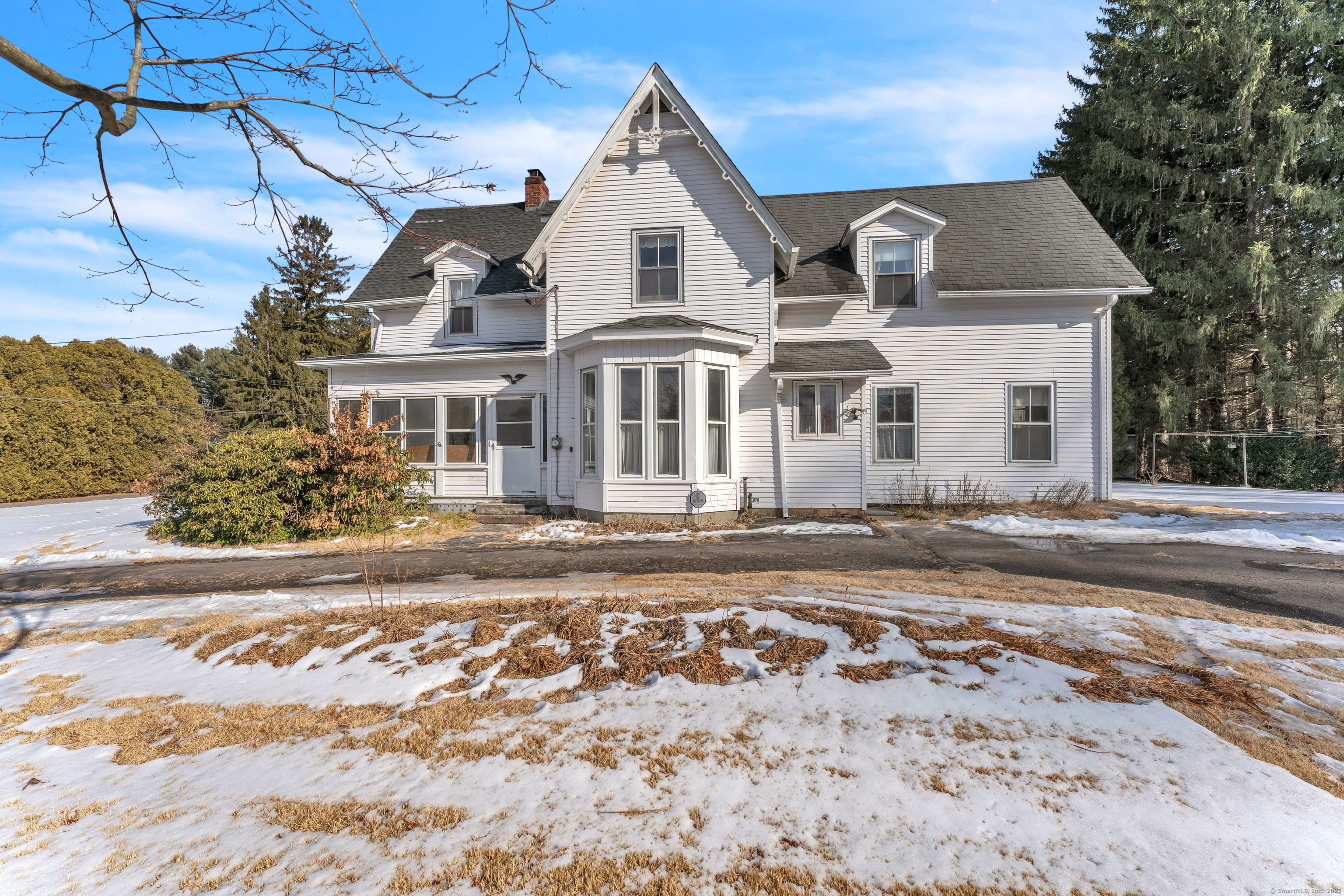 Nestled in the heart of Broad Brook, this stately colonial exudes timeless charm and endless potential. Set on a picturesque and level 2.11-acre lot, the property backs to serene woods and a babbling brook, offering privacy and a tranquil setting. With 4 bedrooms - one without a closet that could easily serve as a home office - this home provides versatile living spaces for modern needs. The main level features an eat-in kitchen, a large dining room, and a spacious living room, as well as a cozy den with a fireplace and a separate area currently set up as an office. You'll appreciate the convenience of first-floor laundry and an inviting enclosed porch to enjoy the seasons. Beautiful wood floors flow throughout the home, adding warmth and character. Outside you will find an oversized detached garage with loft for additional storage. While some updates are needed, the fantastic layout and undeniable charm make this a wonderful opportunity to create your dream home in an unbeatable location.