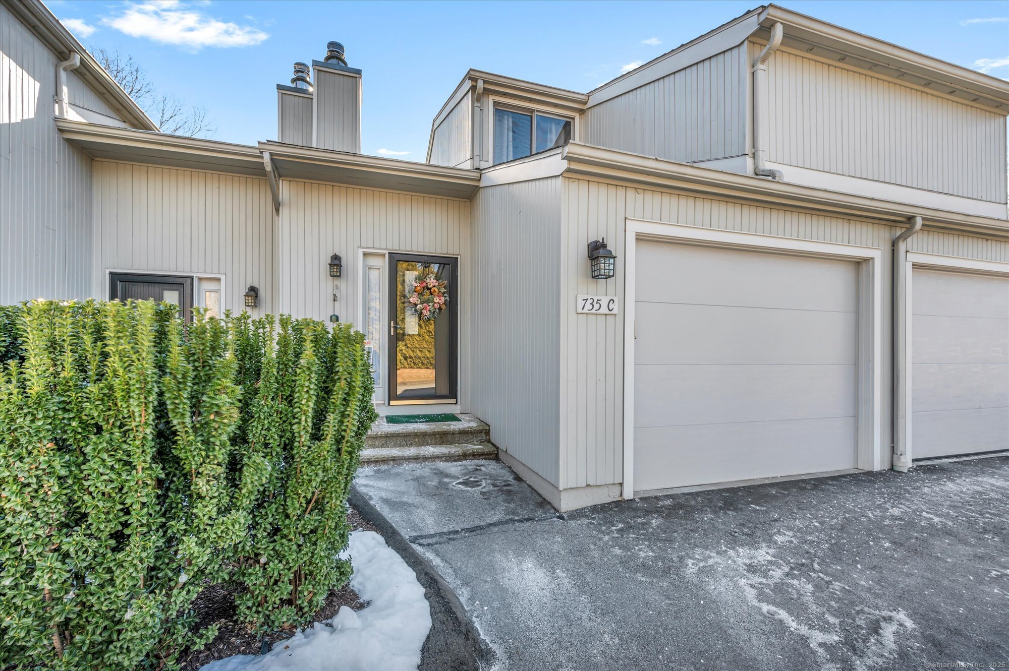 This stylish tri-level townhouse in the Hidden Pond Complex offers a blend of privacy and contemporary charm. Upon entering, you're welcomed by a foyer with a guest closet and direct access to the attached one-car garage. The entry level includes a convenient half bath, while a few steps down lead to the open living room featuring a wood-burning fireplace. The kitchen overlooks the Living room and sunroom that provides access to a private deck. On the mid-level, you'll find a full bath, a laundry area with a washer and dryer, and a linen closet. The second level is home to the primary bedroom, which includes a generous walk-in closet. This bedroom overlooks the sunroom providing ample natural light. The uppermost level hosts the second bedroom, which also features a spacious walk-in closet.