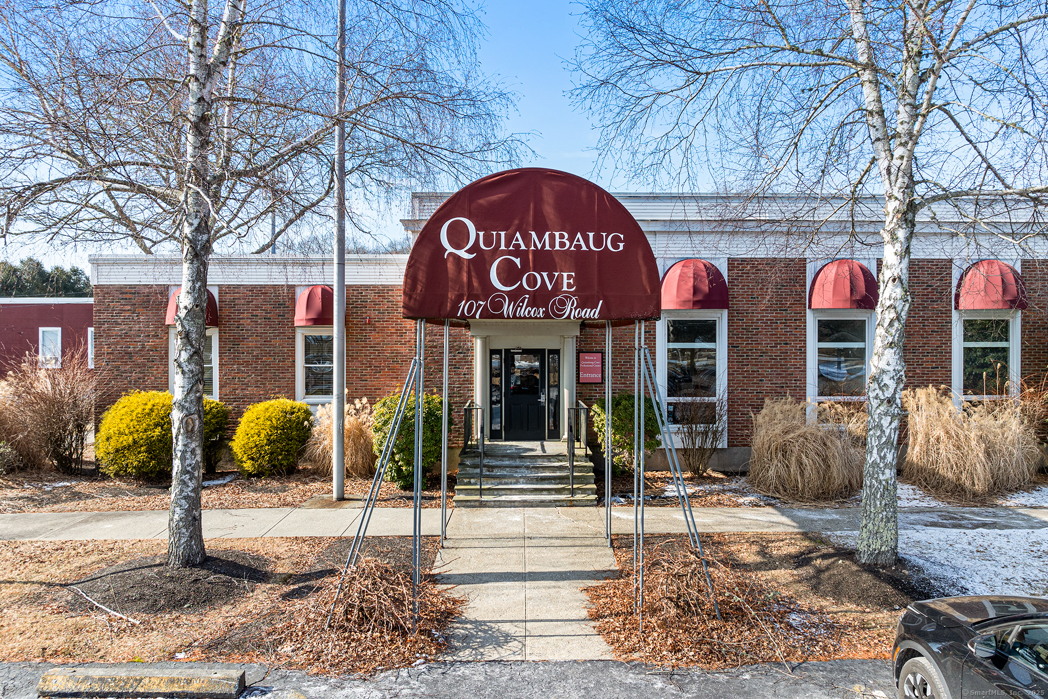 The Quiambaug Cove Professional Center, situated on a scenic 7-acre campus, is arguably one of the finest office buildings in the region. Ideally located just 1 mile from both Stonington Borough and downtown Mystic, it also benefits from high visibility with approximately 7, 300 vehicles passing by daily and convenient access to I-95. The property features a range of premium amenities, including ample parking, secure code-based entrance access, a luxurious waiting area, a kitchenette and a state-of-the-art 45-seat theatre with surround sound, a new projector, and an audio-visual component rack. Gross rent covers all utilities, maintenance, and property taxes, making it an exceptional opportunity for professionals seeking a high-quality workspace.