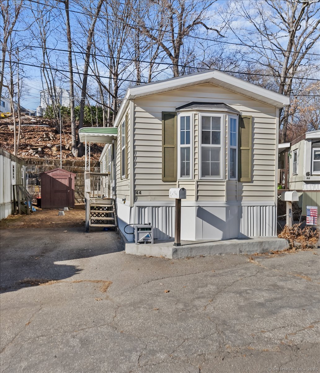 Welcome to Shelton! This 2-bedroom, 1-bathroom manufactured home is situated on leased land at the back of Fairchild Heights. It features a driveway with additional parking available across the street. The white kitchen boasts an open floor plan with a designated dining area and a breakfast bar for extra seating. The home has new flooring throughout and a newer furnace and hot water heater, both approximately five years old. Brand new washer and dryers are located in the bathroom. A detached shed provides additional storage space. The monthly park fee is $424, which includes land rental, garbage collection, snow removal, water, sewer, and park maintenance. The location offers easy access to public transportation and is within walking distance of numerous stores, hotels, and amazing restaurants. It is conveniently located near Route 8 and the Merritt Parkway. Financing is available through mobile home financing companies. Prospective buyers must meet with park management for approval, with a non-refundable application fee of $180. The property must be owner-occupied and is being sold as is, where is. It cannot be rented out. Pets are allowed but require approval from park management. Experience the perfect blend of comfort and accessibility in this ideally located mobile home. Situated in a prime location, this home offers unparalleled convenience! Subject to seller finding suitable housing.