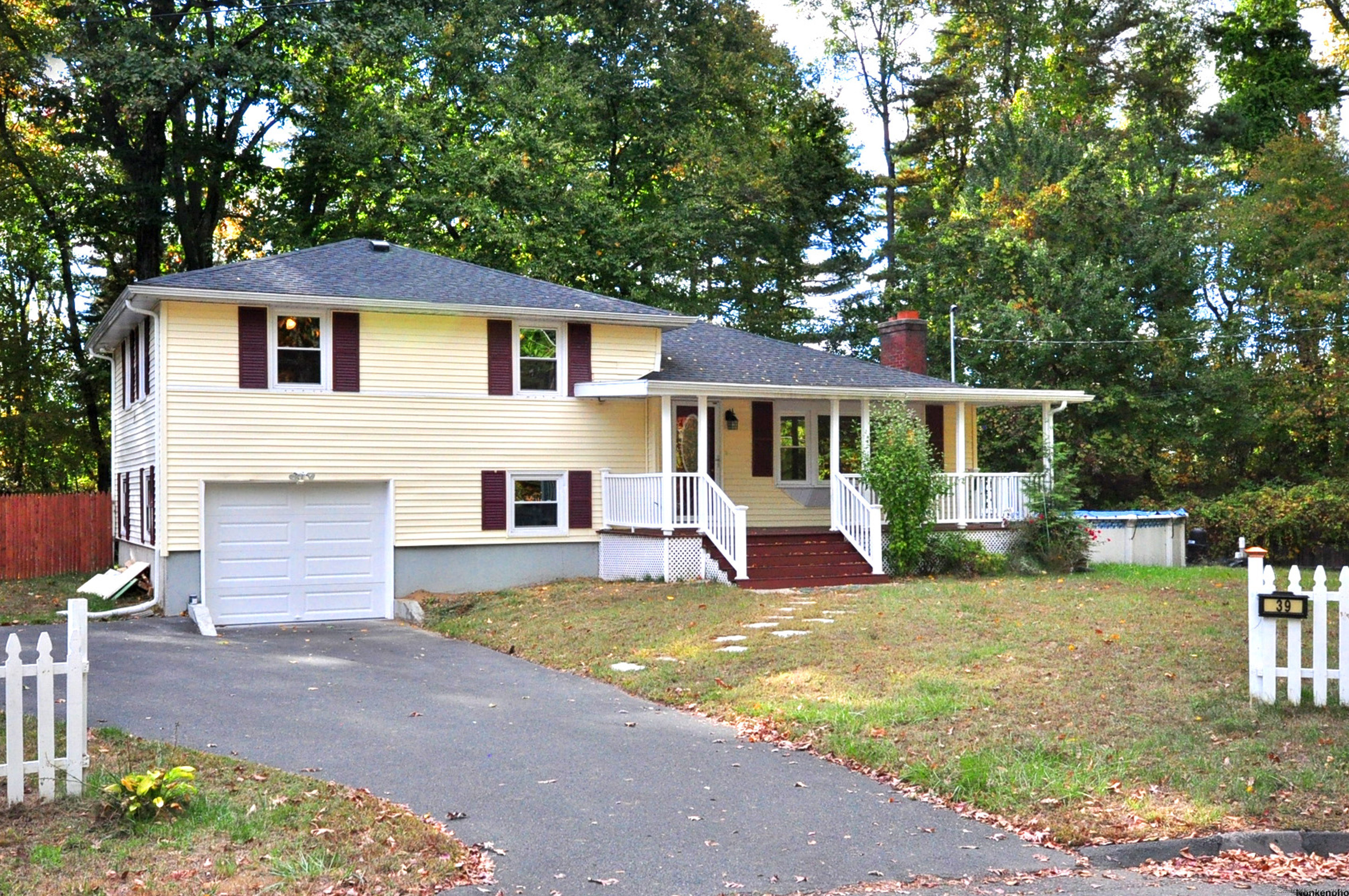 Nestled on a quiet cul-de-sac, this charming split-level home offers 3 bedrooms, 2 full bathrooms, and a 1-car garage on a spacious, well-maintained lot. The inviting front porch is perfect for enjoying your morning coffee or relaxing in the evenings. Inside, the freshly painted interior showcases beautiful hardwood floors throughout the living room, where a cozy fireplace adds warmth and ambiance. The dining area flows effortlessly into a bright and airy sunroom, featuring skylights that fill the space with natural light. From the sunroom, sliding doors lead out to an expansive deck ideal for hosting outdoor gathering and a refreshing pool, perfect for cooling off during the summer. The modern kitchen is equipped with sleek stainless-steel appliances, granite countertops, and plenty of cabinet space. Upstairs, you'll find 3 bedrooms with hardwood floors under the carpet, ready to be finished. The lower level includes a cozy family room for extra living space and a convenient laundry area. Unfinished crawl space basement provides storage. Situated in a prime location, this home is just minutes from highways, shopping, and schools, while also being connected to public utilities for added convenience. This home combines comfort, practicality, and charm, making it a fantastic opportunity for your next home.