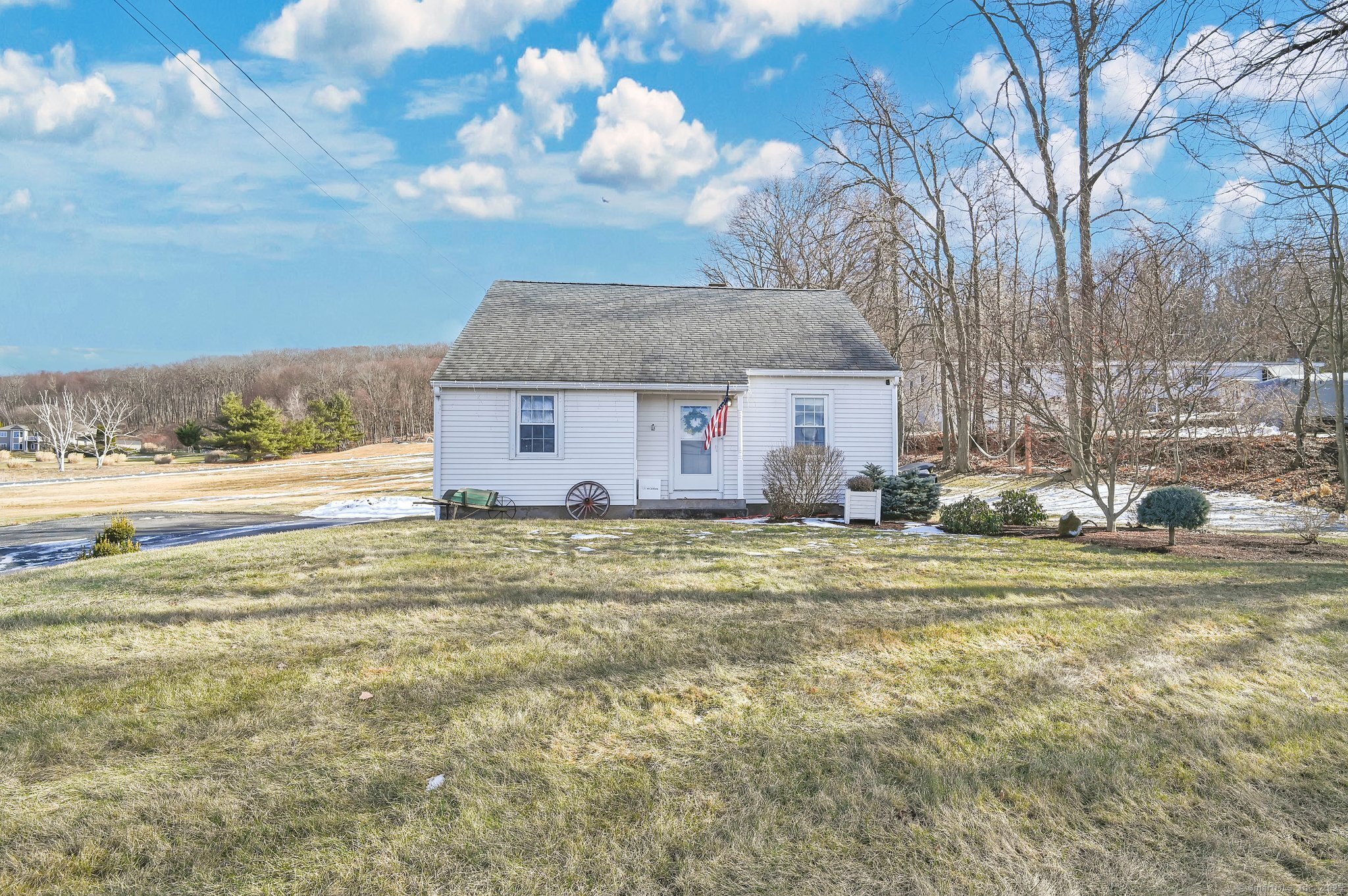 Adorable, 1126 sq. ft. 3-bedroom Cape with sweeping views of the western skies. Situated on 0.6 acres, this home offers updates throughout that include kitchen, baths, bedrooms, hardwood and mechanicals. A welcoming front Foyer gives way to an archway-equipped, open-design Living room and Kitchen complete with recessed lighting, an opened-wall breakfast bar, stainless appliance, granite counter tops, and farm sink. A front-facing, archway-equipped, converted-bedroom, sitting room offers hardwood floors and breath-taking views of the setting sun. The first floor also includes an open-wall Dining room with hardwood and recessed lighting, a tastefully appointed full bath, along with a rear-entrance Mudroom for coats, hats and shoes. The second floor offers 2 lovely bedrooms along with another beautiful full bath. The unfinished lower-level includes new mechanicals - boiler, burner, and hot water heater - as well as a tremendous opportunity for a future finished space. The grounds have unobstructed views of the westerly skies, a large parking area, and plenty of room for a 2-car garage. This is a 'must see'.