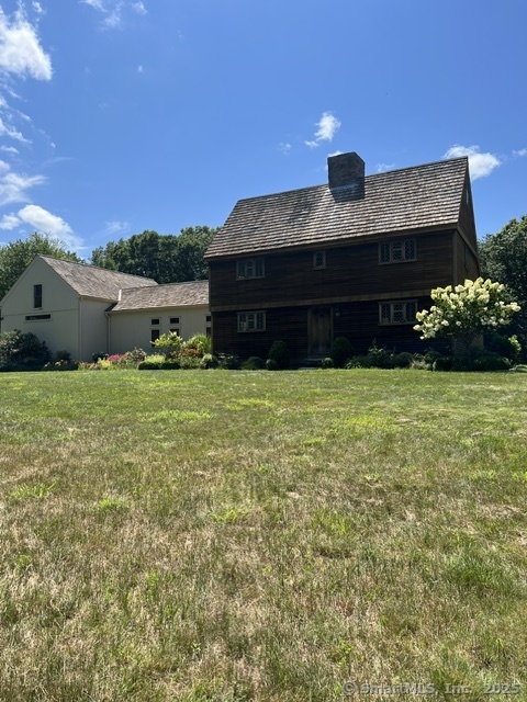 Step into the past while enjoying modern luxury in this beautifully restored 17th-century home. Originally built between 1690 and 1730 in Wilbraham, Massachusetts, this rare architectural treasure was carefully dismantled, relocated, and meticulously reconstructed on a sprawling 61-acre estate in Haddam, CT. Brimming with character, the home retains its original charm with hand-hewn beams, wide-plank floors, and grand walk-in fireplaces, all thoughtfully preserved to honor its history. At the same time, it has been tastefully updated to offer the comforts and conveniences expected in a modern home. The 800-square-foot kitchen and dining area are currently being renovated with high-end finishes-offering a unique opportunity for the next owner to personalize this extraordinary space. The exterior is just as captivating in the spring and summer months perennial gardens and rolling fields frame the front of the home, while a courtyard and patio-crafted from antique granite-invite endless possibilities for entertaining. Whether hosting a wedding, a retreat, or an intimate gathering, this breathtaking setting provides the perfect backdrop. Surrounded by nature, this estate offers complete privacy and tranquility. Stroll through your own forest and take in the beauty of New England's changing seasons. More than just a home, this is a rare chance to own a living piece of America's past, don't let this once in a lifetime opportunity pass you by. Professional photos coming soon