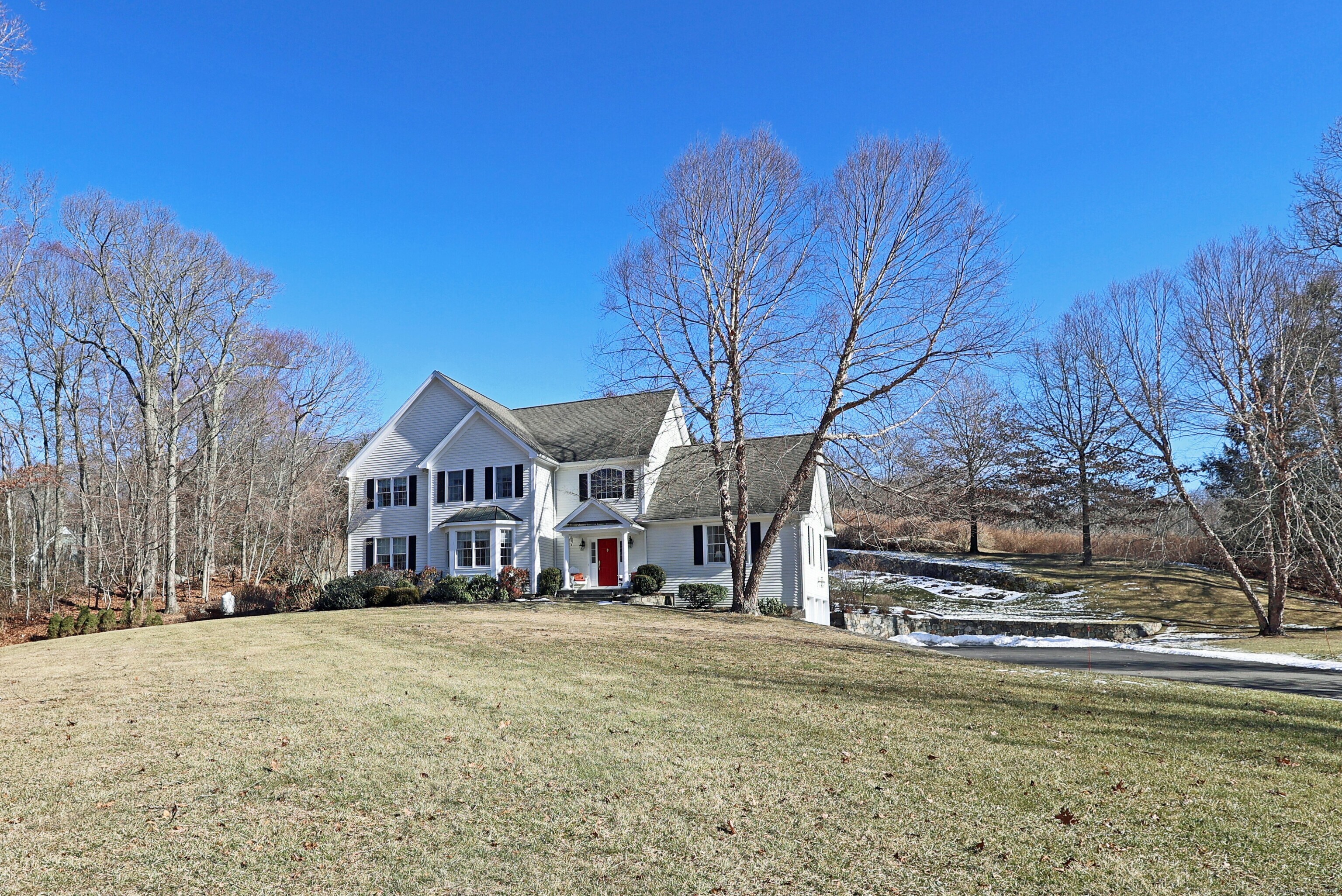 Pride of ownership abounds in this immaculate home, custom built in 2004 by the original owners with extensive recent updates. Exceptional private setting on 2.18 tranquil acres w/stone walls, mature professional landscaping including specimen trees, perennial gardens, stone patio, plus 5 minute walk to scenic Huntington State Park w/over 1, 000 acres of hiking/biking trails & 5 ponds. Impressive from first glimpse, this stately home offers a gracious driveway w/stone entry pillars, 3 car garage, standing seam copper roof overhangs, & elegant front entry portico. Attention to detail abounds with two story foyer; 9' ceilings; custom millwork incl. wainscot, moldings, & built-ins; French doors; plus generous proportions throughout. Total 3, 773 sf w/11 rooms, 4 bedrooms (5 BR septic for expansion) & 2/1 baths. The first floor is drenched in light & offers a flexible floor plan including private library/office; den/study; formal LR; oversized DR for entertaining; state of the art kitchen w/center island & sunny breakfast area, open to the inviting FR with gas fireplace; plus the four season sunroom w/bead board paneling, overlooking the stone patio & expansive lawn. Lux primary suite w/newly remodeled bath featuring soaking tub & large glass shower, plus double walk in closets/dressing area. The huge unfinished basement offers great storage & unlimited potential. Redding, the Vermont of CT offers award winning schools in a vibrant pastoral community just 56 miles to Midtown.