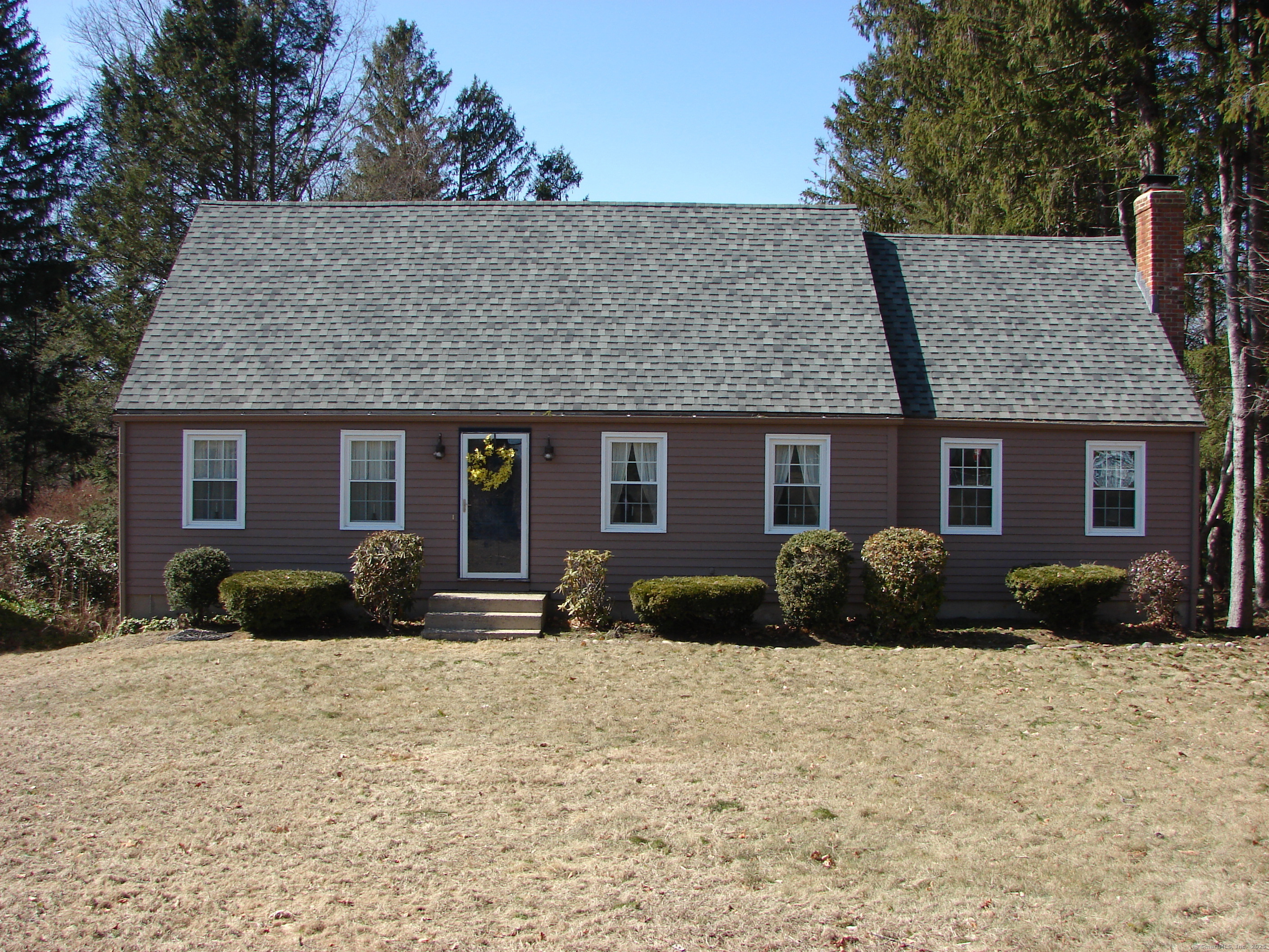 Nestled in the quaint village of Collinsville, this inviting 3-bedroom Cape sits on a desirable corner lot, with a peaceful cemetery on one side along the back of the property and the local school just across the street. Recent updates include new roof, freshly painted exterior, newly painted back deck and refreshed bedrooms - making this home truly move-in ready. Inside, the home exudes warmth and character, featuring a spacious family room with wide-plank wood floors, a wood stove with a rustic railroad tie mantel, and a charming country-style entryway to the dining room. A small office space off the family room provides a perfect work-from-home nook. The living and dining rooms are comfortably carpeted, with the dining room offering built-in hutch and elegant crown molding. A stunning sunroom, located between the kitchen and living room, boasts built-in shelves and glass doors that open to a gorgeous deck stretching the length of the home - perfect for relaxing or entertaining. The kitchen also offers direct deck access, making alfresco dining effortless. A first-floor full bath includes a walk-in shower and a convenient laundry area. Upstairs, the primary bedroom features ample storage and wide-plank wood floors, with direct access to a full bath, also accessible from the hallway. Additionally, the home includes a partially finished walkout basement, offering extra living space and convenient access to a storage area and a two-car under-house garage.