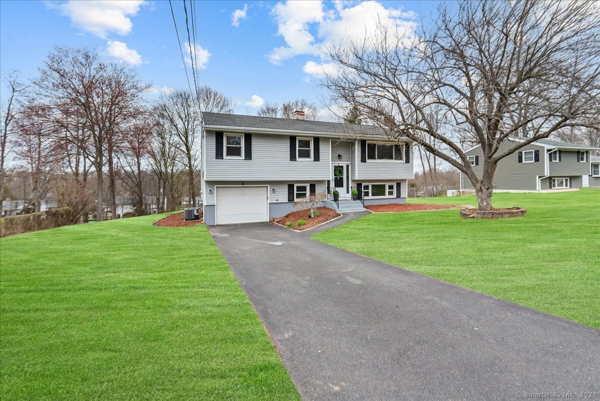 Step into this lovingly maintained 3-bedroom, 2-bathroom Raised Ranch Style home on Wallingford's east side, where over 1700+ square feet of bright, spacious living awaits. This home is a perfect blend of charm and modern flair, ready to welcome you with open arms. Hardwood floors in all 3 Brs. Picture yourself unwinding by the cozy wood-burning fireplace in the luminous living room with hardwood floors, or hosting unforgettable gatherings in the expansive family room downstairs, complete with a gas fireplace for added warmth. The kitchen featuring sleek granite counters, stainless steel appliances stove(2025) and dishwasher (2025), and sliders that lead to a fabulous 3-level deck and a 4th level concrete patio perfect outdoor gatherings. The generous back yard is your personal oasis, ideal for entertaining or starting that garden you've always dreamed of with the 16 ft x 10 ft shed. With central air (newer condensor 2020), comfort is guaranteed year-round.