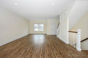 The first flight of stairs leads to the large open floor plan.