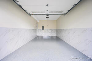 A single car garage for your convenience. One face in parking spot adjacent to the garage.