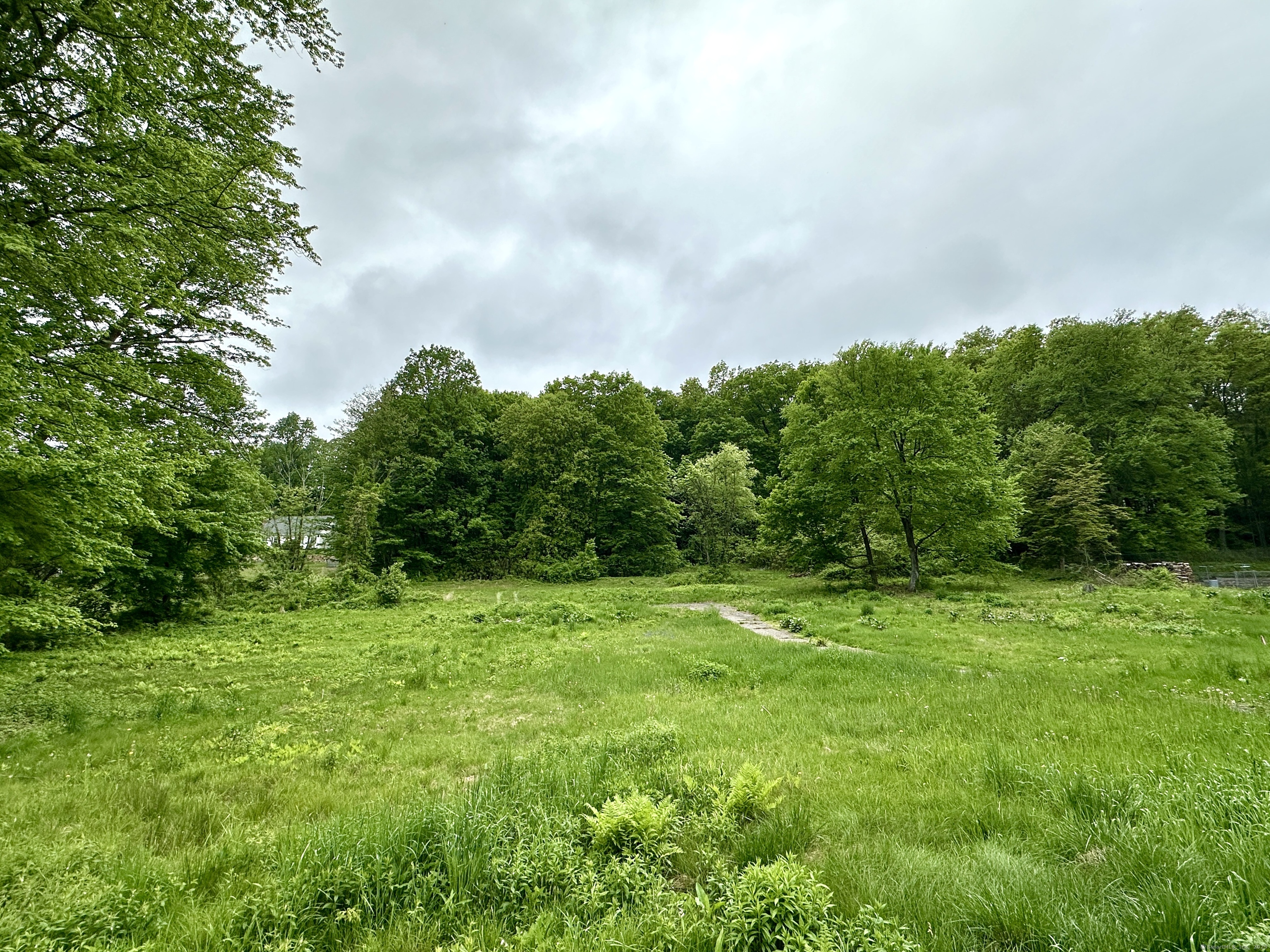 7.8 Acres with 180ft of frontage on South Grand St. Suitable for one home or do your diligence on a possible subdivide. Lightly sloping uphill lot with western exposure and views from the top. Close proximity to I-91. A-2 Survey and Perc test being completed.