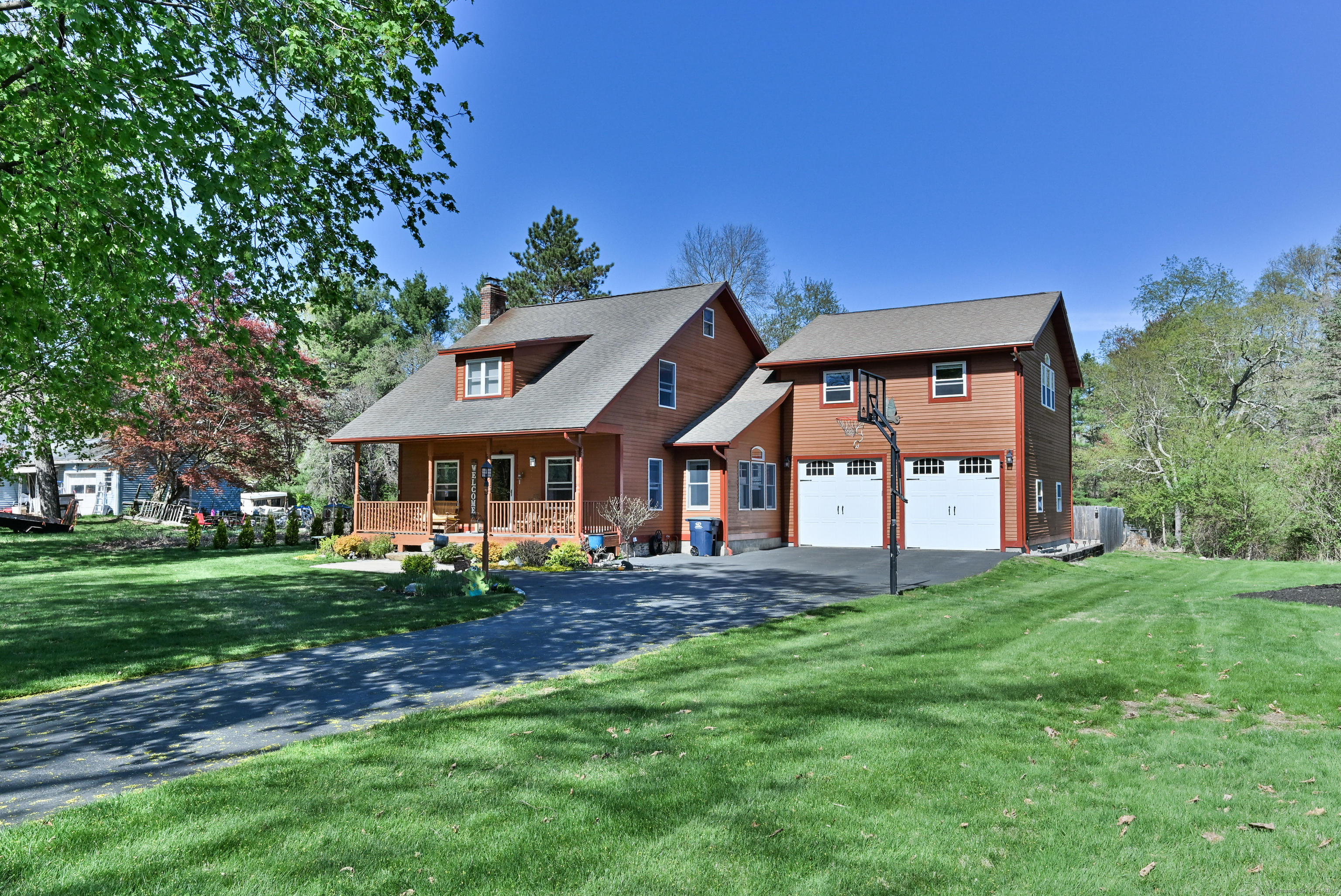 This meticulously updated & beautifully renovated home in desirable Thompson - just a minute from the Dudley line boasts over 2,300 SF of thoughtfully designed living space. The spacious heated 3-car attached garage features both front & rear garage doors & has an incredible bonus room above, complete w/vaulted ceilings, a stunning propane fireplace, & a custom wet bar-perfect for entertaining. The bright & open kitchen is a chef's dream, showcasing gleaming granite counters, a two-tier island, & ample workspace. The kitchen flows seamlessly into the dining area, cozy living room, & den featuring a wood stove. A convenient mudroom, first-floor laundry in the half bath, & a welcoming layout add to the home's ease of living. Upstairs, you'll find the spectacular family room, two generous beds, & a beautifully updated full bath. A hidden staircase leads to a finished 3rd floor w/built-in beds & a walk-in closet-ideal for a creative retreat or additional sleeping quarters. Enjoy outdoor living from the composite front farmers porch or rear deck that overlooks your fenced yard, complete w/ a fire pit, jacuzzi w/pergola, multiple sheds, & exterior has timeless cedar siding. Beyond that lies a sprawling, flat yard with covered RV storage. This home is equipped w/ state-of-the-art Buderus wall-mounted boiler, Buderus water heater, & a hydro-air heating system w/central air. With too many features to list, this exceptional property truly must be seen to be appreciated!