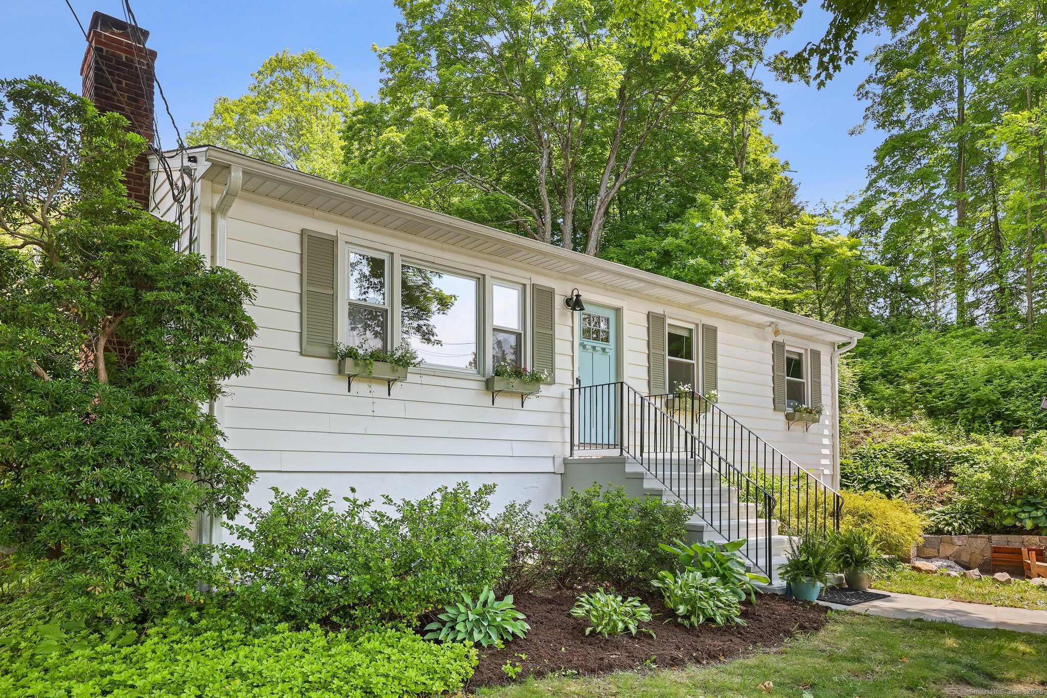Charming ranch located close to town - just over a 1/2 mile stroll to vibrant downtown Ridgefield - and move-in ready! Upon entering, you are greeted by gleaming hardwood floors, a gorgeous stone fireplace with built-ins, and lots of light. Storage is abundant, including cedar closets, shelving, and cabinets. Some of the lovely details include solid wood doors and updated lighting. The house boasts three bedrooms and one and a half baths. There is an expansive lower-level family room and laundry/mudroom. There is also an oversized one-car garage that can accommodate a shop or future expansion in addition to a car. The home is in perfect move-in condition, and if more space is needed, plans are available for a second-story expansion. A bonus - it's on town water and sewer! Outside, you'll enjoy perennial flower gardens in the deep backyard, the sunny deck, beautiful stonework, a storage shed, and a fire pit. Recent improvements include fresh paint, refinished hardwood floors, tile backsplash in the kitchen and baths, a new front door, new attic stairs, new wall AC, and so much more! Don't miss out! MORE EXTERIOR PHOTOS TO COME. AGENT OWNER.