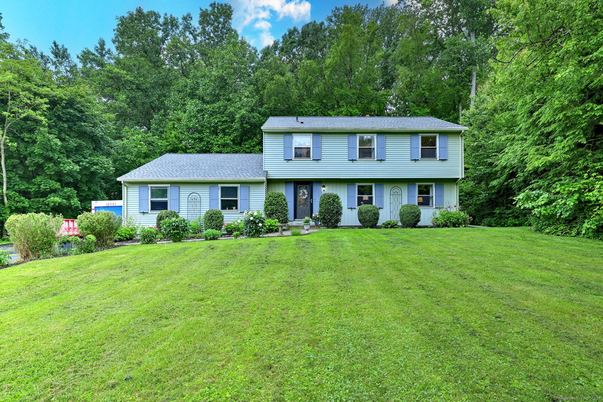 Welcome home to 138 Wildwood Circle! This charming Colonial, has been lovingly maintained by the same owners for the past 18 years! Built in 1977 it offers 2,080 sq ft of well-designed living space. The main level features a spacious eat-in kitchen with a breakfast bar, a formal dining room, a comfortable living room, and a great room/family room with new laminate flooring. A sliding glass door off the family room leads to a spacious deck-perfect for outdoor dining, entertaining, or simply relaxing. Gleaming hardwood floors add warmth and character throughout the main living areas. Upstairs, you'll find three generously sized bedrooms, including a large primary suite complete with three closets and a private bath. An additional full bathroom serves the other two bedrooms, with a convenient half bath on the main level. Major updates include a newer roof (2019), furnace (2024), and oil tank (2025), giving you peace of mind for years to come. The home also features a full basement with approximately 200 sq ft of finished space-ideal for a playroom, workout area, or home office. Enjoy the outdoors with lovely garden beds and a 2-car garage for added convenience. Tucked away in a desirable neighborhood, this home offers both comfort and community. Don't miss the opportunity to make it yours!