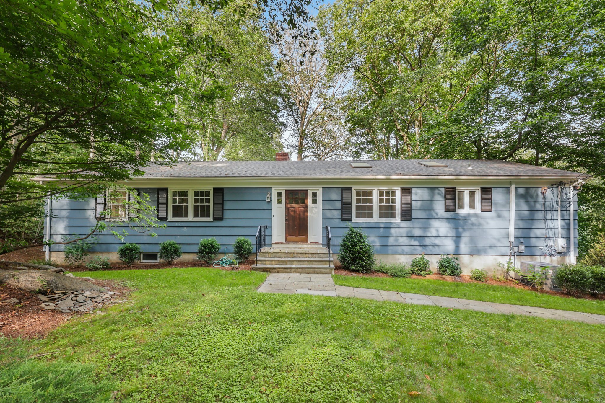 Spacious & Updated North Stamford Ranch with In-Law Potential! This updated Ranch offers generous living spaces, flexible layout, and easy in-law or au pair potential-perfectly situated in a prime lower North Stamford location! Freshly painted throughout with gleaming refinished hardwood floors, this home also boasts updated bathrooms and an impressive eat-in kitchen. Step into the spacious Entry Foyer that flows into a large, light-filled Living Room with a classic fireplace and picture window. The separate Dining Room easily accommodates holiday gatherings and dinner parties. The expansive Eat-In Kitchen features two skylights and a large adjacent Laundry Room for added convenience. The Bedroom Wing includes a well-sized Primary Suite with a Walk-In Closet and Full Bath featuring a separate shower. Two additional Bedrooms and a Full Hall Bath complete the main level. The walk-out Lower Level offers incredible versatility-with a Family Room (fireplace and sliders to the patio and yard), Playroom with wet bar, Full Bath, additional Bedroom, and a large workshop that connects directly to the oversized 2-car Garage. Fantastic location just minutes from the Merritt Parkway, shopping centers, and a quick ride to the train, I-95, and the vibrant Downtown Stamford & Harbor Point districts. A must-see!